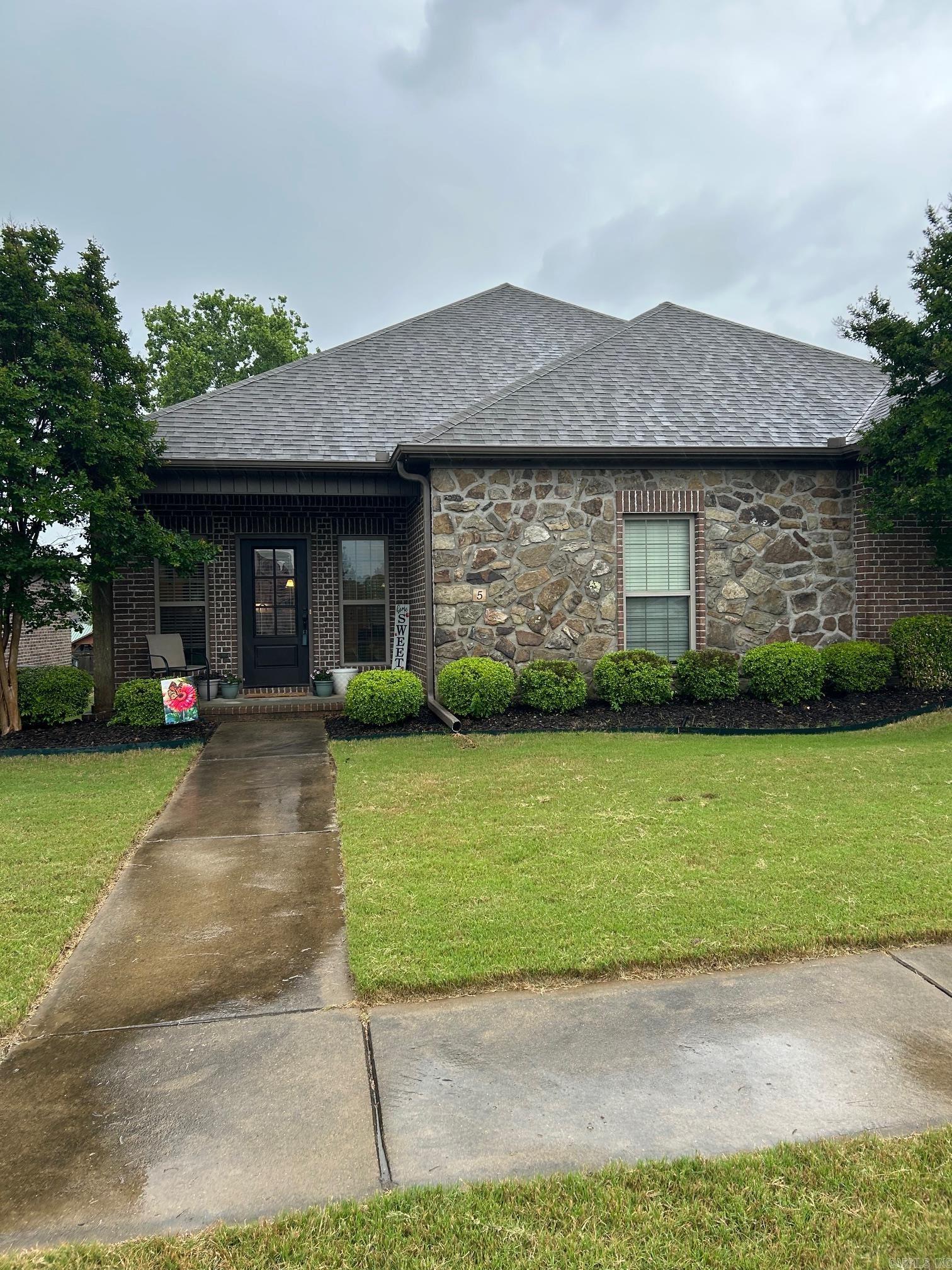 Beautiful home in Southwind development, private alley entrance behind the home with 2 car garage.  Spacious open floor plan with large wrap around bar and cabinets.  Kitchen has lots of cabinets with room to entertain with the kitchen dining room open to each other.  Master suite has a large walk in closet with double sink vanity in the bathroom, soaking tub and walk in shower, privacy commode separate.  Home features tall ceiling with crown molding, wood flooring, covered front and back porch and nice green spaces.  Well maintained and landscaping is beautiful and professionally done.  Stone features along the front of the home. Separate laundry room with pantry. Pool and picnic area for homeowners. Dont miss this one!