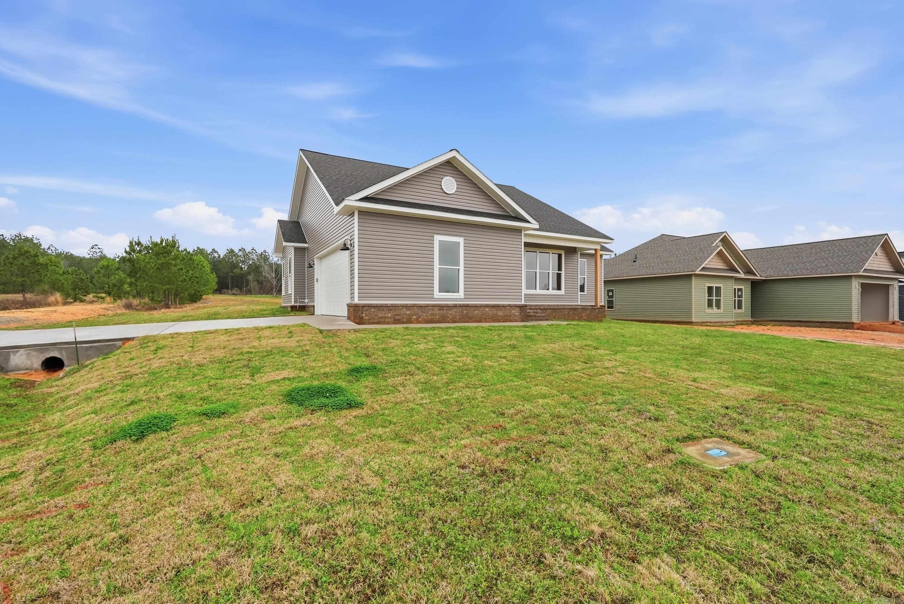 Introducing a beautiful new construction nestled in the serene community of Deer Creek Springs, perfectly positioned at the Saline County/Grant County Line. This stunning home, set on a spacious corner lot, offers a blend of comfort and style with its thoughtfully designed layout. It features three bedrooms and two modern bathrooms, creating a welcoming and functional space for family living. The open floor plan enhances the sense of space and connectivity throughout the home, making it ideal for both relaxing and entertaining. At the heart of this home is a gorgeous kitchen with granite countertops and tasteful decorator touches that reflect a keen eye for design. The custom woodwork throughout the house adds to its charm, highlighting the unique architectural features that make this property truly special. Residents will appreciate the gated subdivision, which provides an additional layer of security and peace of mind, allowing for leisurely family time, bike rides, and active community involvement. Call us today to see this beautiful home in person!