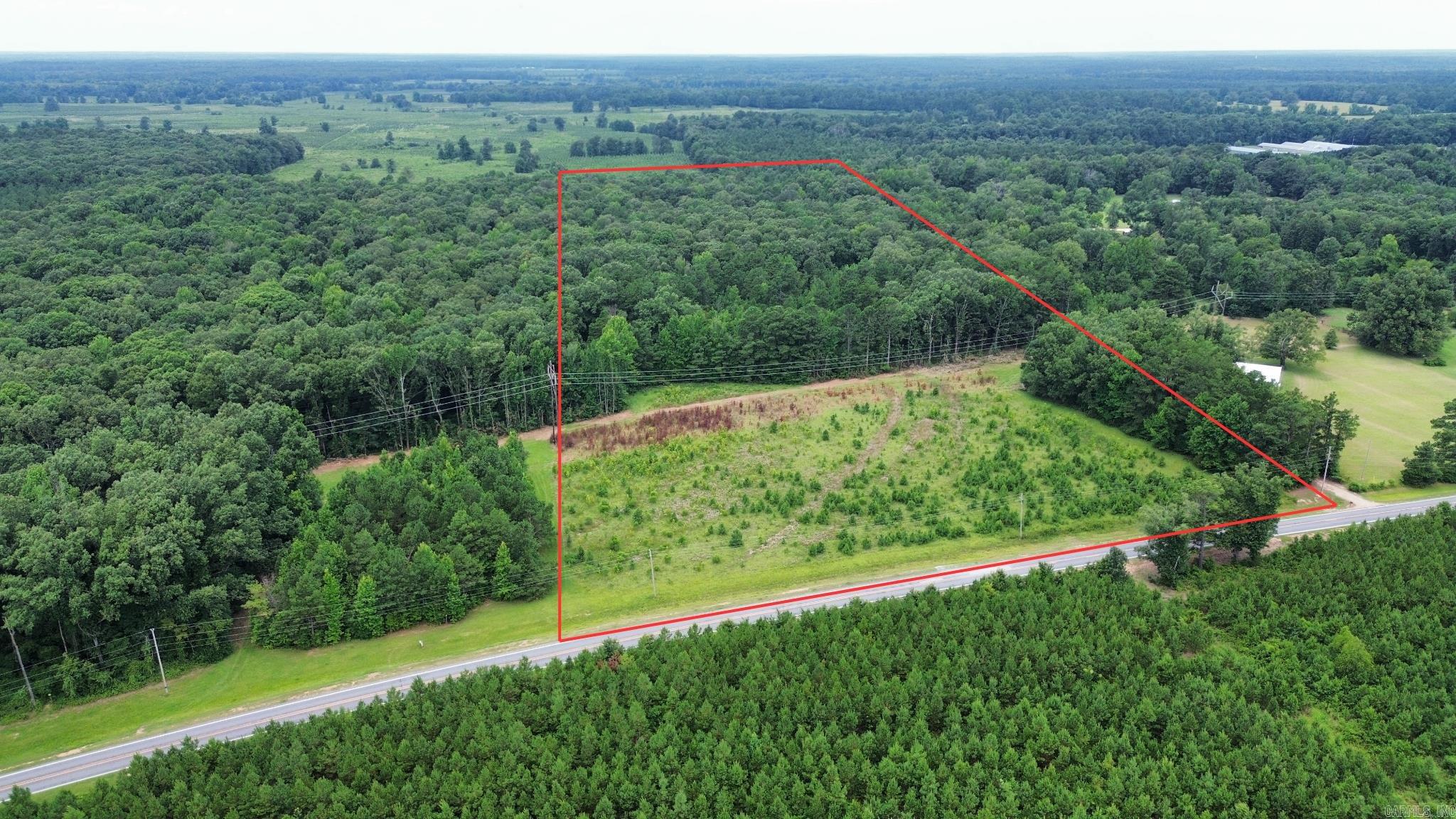Discover this excellent acreage opportunity in Cleveland County with paved road frontage along Highway 54. The property features a cleared homesite area near the road, making it ideal for building your dream home, while the back portion offers mature timber, providing privacy, recreational opportunities, and potential future value.  Outdoor enthusiasts will appreciate the hunting possibilities with abundant wildlife, while the standing timber offers the potential for a return on your investment. Whether you're looking for a rural homesite, a recreational retreat, or a long-term land investment, this property provides a great combination of accessibility, privacy, and opportunity.  (Final sale price tbd by a new survey and price per acre.)