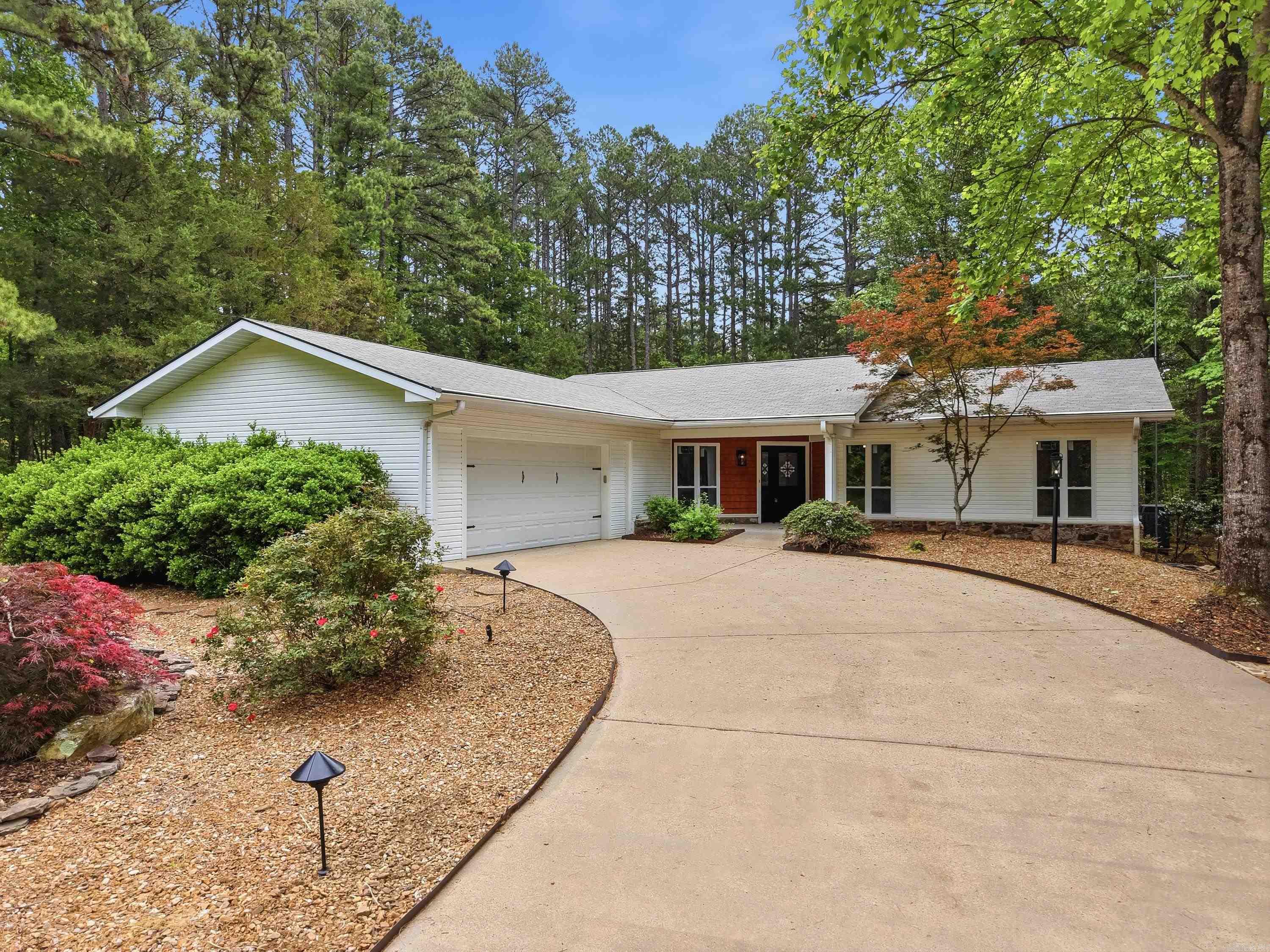 Great one-level home ideally surrounded by Mountain Ranch golf course on a quiet, peaceful street. This beautifully maintained property features new windows, newer flooring throughout, and stunning quartz countertops in the kitchen, primary bath, and laundry area. The spacious primary suite offers a large walk-in shower and elegant coffered ceilings, also featured in the living and dining areas. Enjoy year-round comfort in the enclosed heated and cooled sunroom overlooking the beautifully landscaped backyard, or unwind on the deck with cable railing—perfect for relaxing or entertaining. The home includes a large garage with extra storage, a generous walk-in pantry, and a well-designed laundry space with abundant storage throughout. Cozy evenings await by the stone fireplace with gas logs and blowers. Located just 5 minutes from Mountain Ranch Clubhouse and 10 minutes to Greers Ferry Lake, this home also gives you access to the incredible Fairfield Bay lifestyle—featuring 3 swimming pools, scenic hiking and biking trails, ATV trails, pickleball courts, tennis, bowling, miniature golf, and two 18-hole golf courses. Virtually staged. See agent remarks.