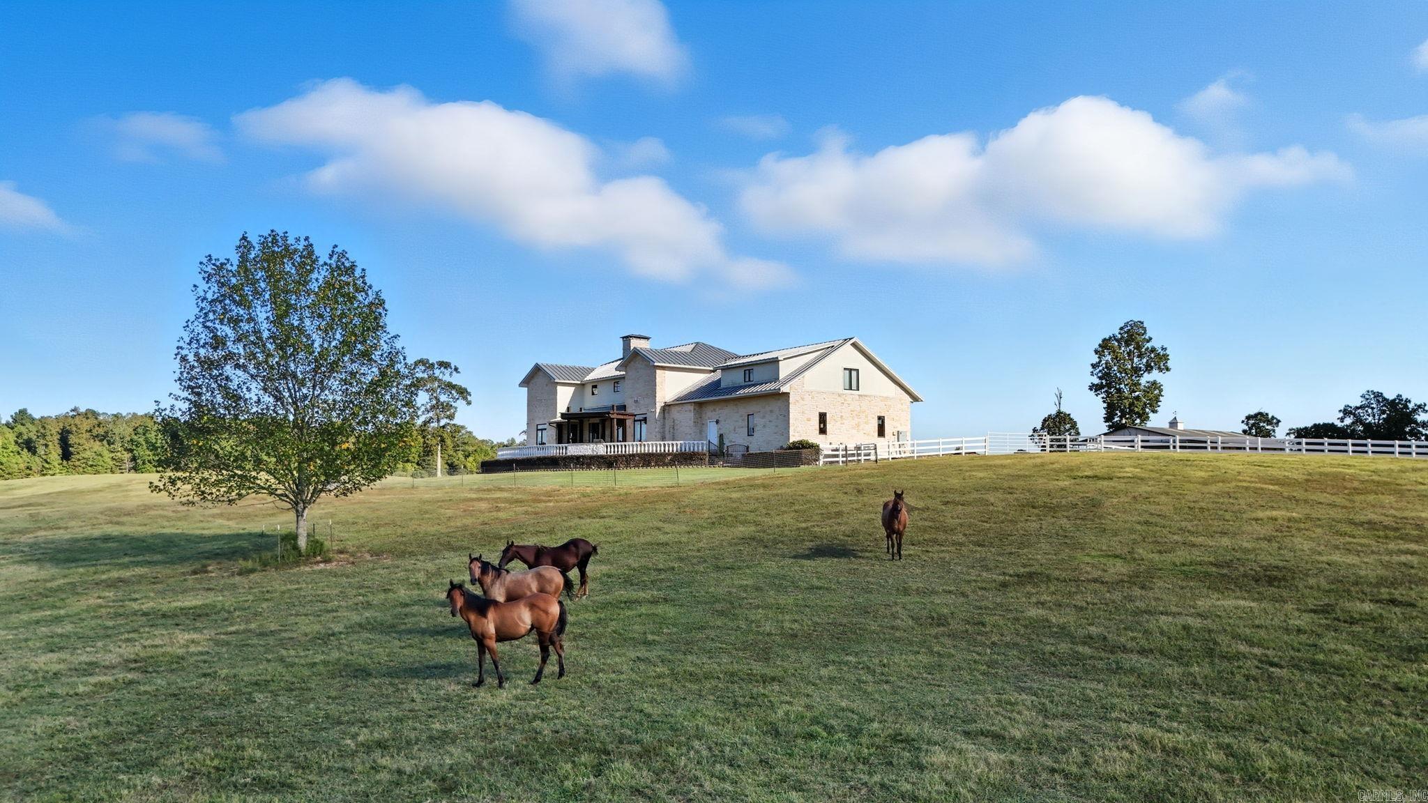 Texas-Style Elegance Meets Arkansas Living!   Welcome to 905 Sunshine Road in Royal, Arkansas. A custom built masterpiece sitting on 40 picturesque acres of rolling pastures, serene ponds, and stunning mountain views. Built in 2007, this approx 4,348sq feet estate combines Texas-inspired architecture with the comfort of Arkansas living, offering the perfect retreat for those seeking space, style, and functionality. This home is more than just a residence, it's a lifestyle. From the Texas-style design to the Arkansas charm of open land and views, every detail has been carefully crafted to balance beauty, comfort, and practicality.