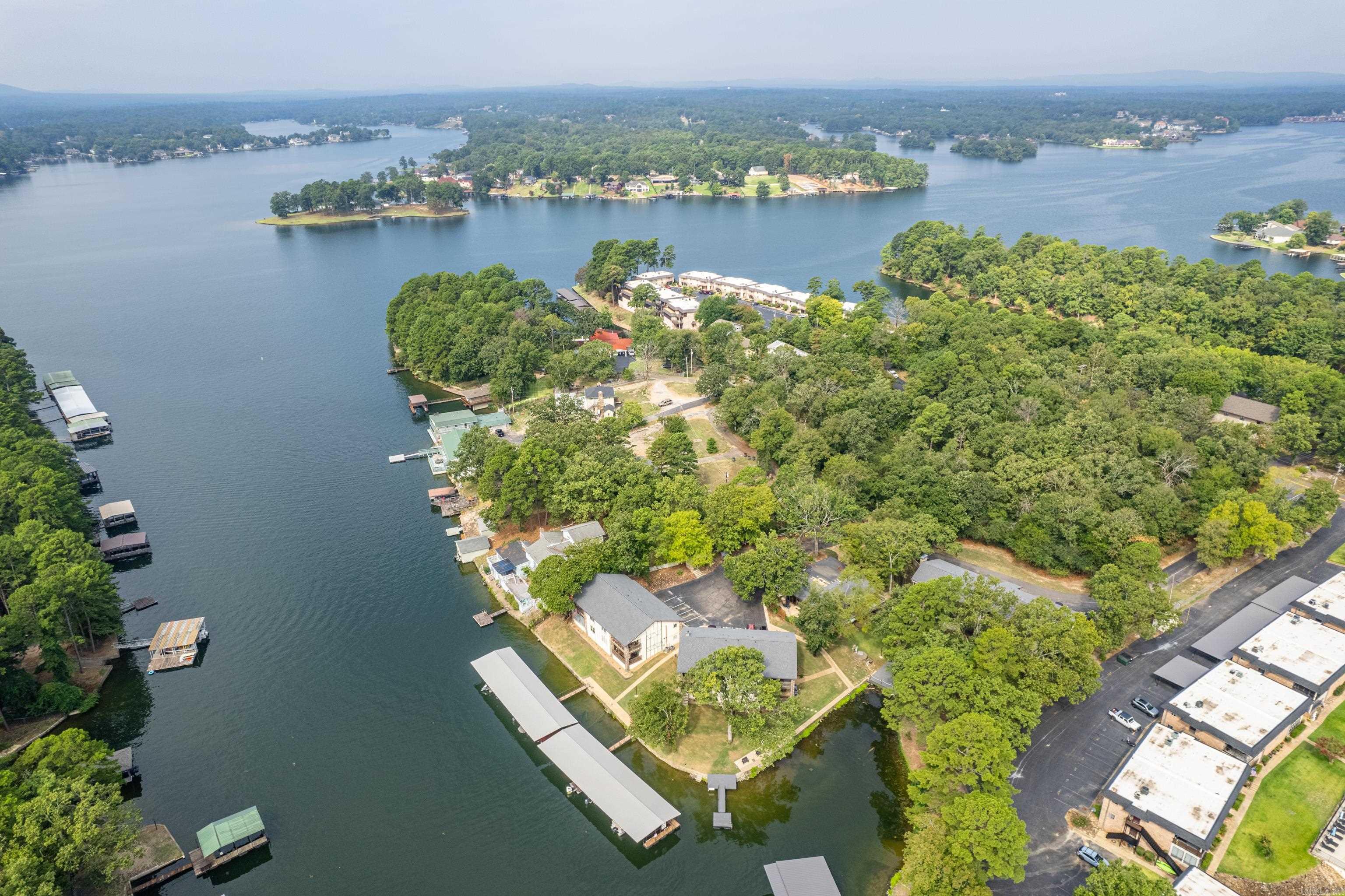 Located in one of Hot Springs’ most conveniently situated condominium communities, this spacious upstairs unit offers an eye-catching view of Lake Hamilton. Enjoy sweeping lake vistas from the outdoor deck, looking to the main channel with views extending toward Sam’s Pizza. The complex provides a quiet residential environment. This is one of the largest units in the complex and has been newly updated throughout. Offered fully furnished, the condo is perfectly suited for an easy weekend getaway or comfortable full-time residence. A covered boat slip is conveniently located just outside the building, providing effortless access to the water.  An exceptional opportunity to enjoy low-maintenance, luxury lake living in a prime Hot Springs location
