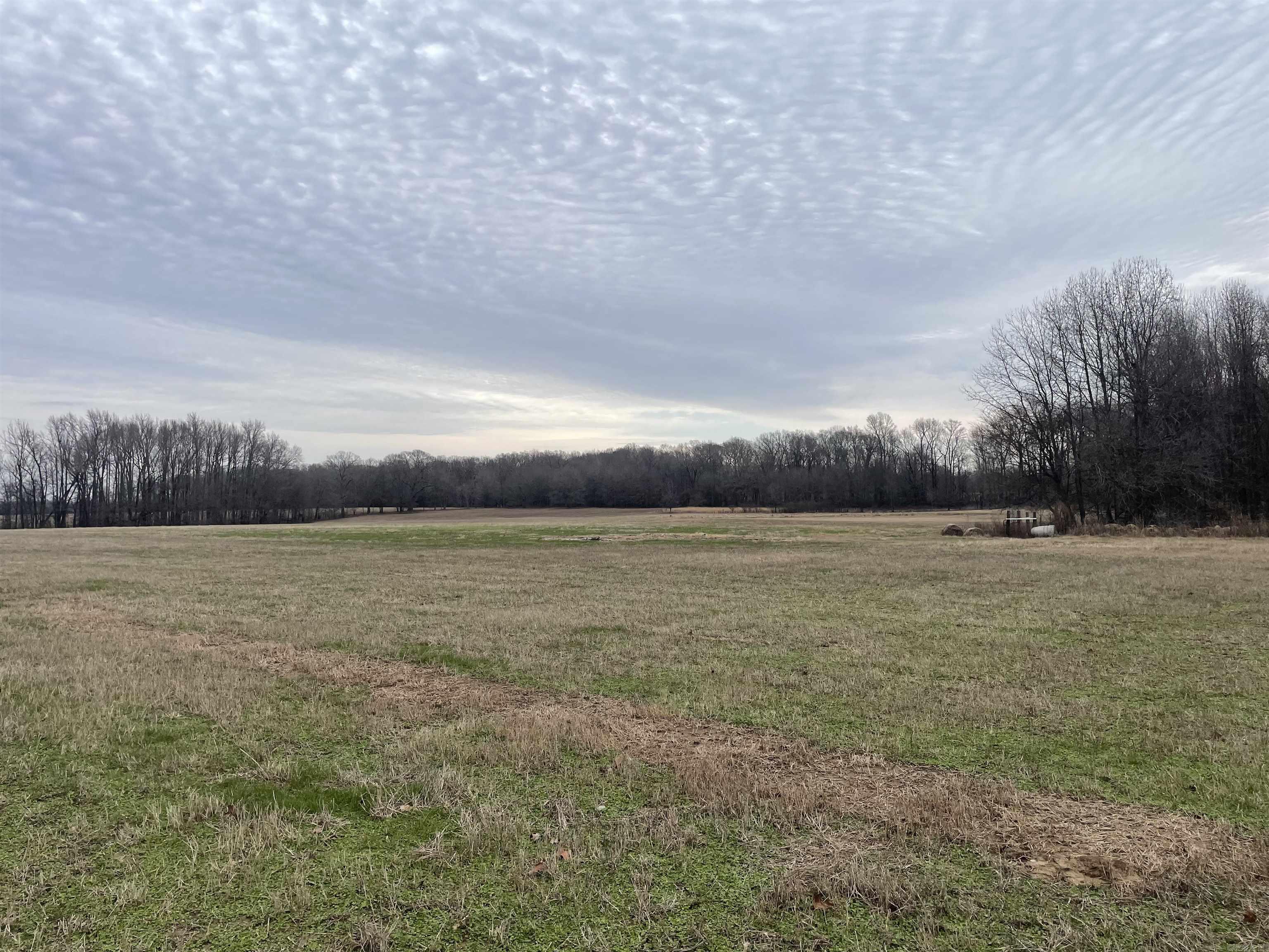 The building site of your  dream home awaits. This  location offers  large trees on part of the land  and a large open area previously used to hay, and pasture. This area is great for building or installing a premanufactured home. This lot is at the corner of Piney creek and Goff Road