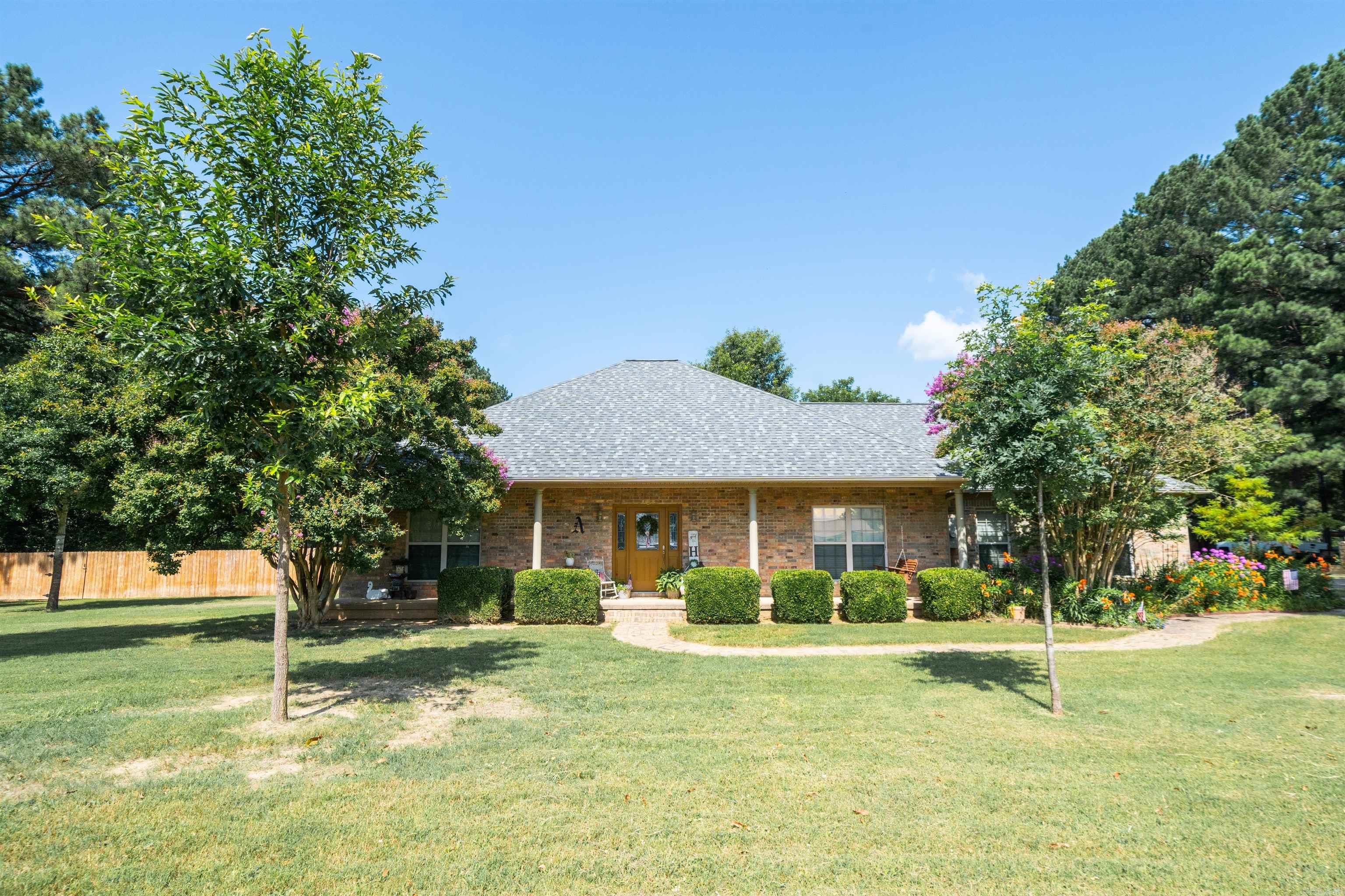 This spacious home is situated on one acre and offers comfortable living with hardwood and tile flooring throughout. The well-designed floor plan features generously sized rooms, abundant storage, and a formal dining room. The two-car garage also includes a 4' x 6' MightySafe storm shelter with an interior-opening, walk-in door for added peace of mind. The property has been immaculately maintained, with beautiful landscaping that enhances its curb appeal. The spacious, fenced backyard includes a covered back porch, creating the perfect setting for relaxing or entertaining.  A standout feature is the 30' x 40' detached shop, complete with workbenches and shelving that will convey to the buyer. The shop provides excellent space for projects, equipment, hobbies, or additional storage. A double gate behind the shop offers convenient access and an ideal area for parking trailers, boats, or other recreational equipment.  Located in the Vilonia School District and just minutes from Conway, this home offers convenient access to shopping, dining, schools, and other everyday amenities.