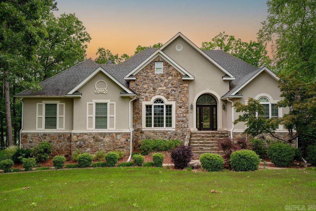 Stunning Lakefront Home in Hawks Pointe!  This beautiful lakefront home sits at the point of Hawks Pointe Subdivision, offering a 180-degree water view. Enjoy a low-maintenance exterior, covered deck, and a manicured lawn with an extra lot. The main level features a Master Suite & second bedroom, while the lower level includes a third bedroom, safe room, bonus/game room, and wet bar. A rock path leads to the lake, perfect for enjoying the outdoors. Additional perks include a circle drive, attached two-car garage, and detached garage. Resealed decks (2016). Don’t miss this rare lakefront retreat!