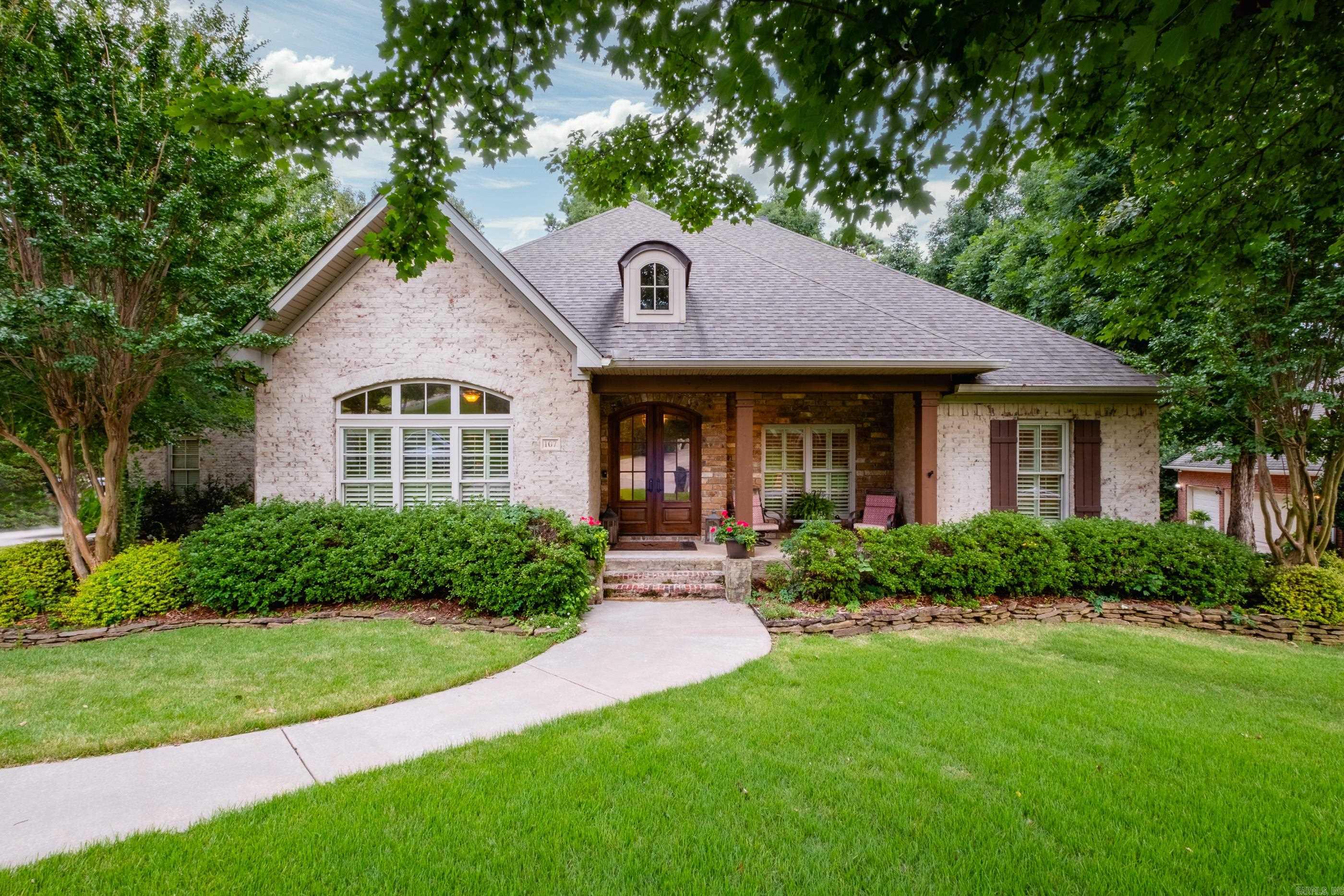 Nestled on a quiet circle in the desirable Lamarche subdivision of Chenal Valley, this beautifully maintained home sits on a private half-acre lot surrounded by mature trees and gorgeous landscaping. Enjoy outdoor living from the screened porch, new deck, iron-fenced backyard, and additional storage beneath the home with a concrete slab. Inside, site-finished hardwood floors, plantation shutters, custom built-ins, and abundant natural light create a warm, inviting atmosphere. The chef's kitchen features custom cabinetry, a spacious island with bar seating, double wall ovens, a gas cooktop, and a breakfast area. Designed to live like a one-level, the main floor includes the primary suite, guest bedrooms, office/den, formal dining room, and spacious laundry room. The primary suite features two walk-in closets. Upstairs offers a versatile 4th bedroom or bonus room with its own mini-split system. Roof replaced in 2021. The primary suite features two spacious walk-in closets. Built in 2012 by Bill Parkinson, this was the final home completed in Lamarche.
