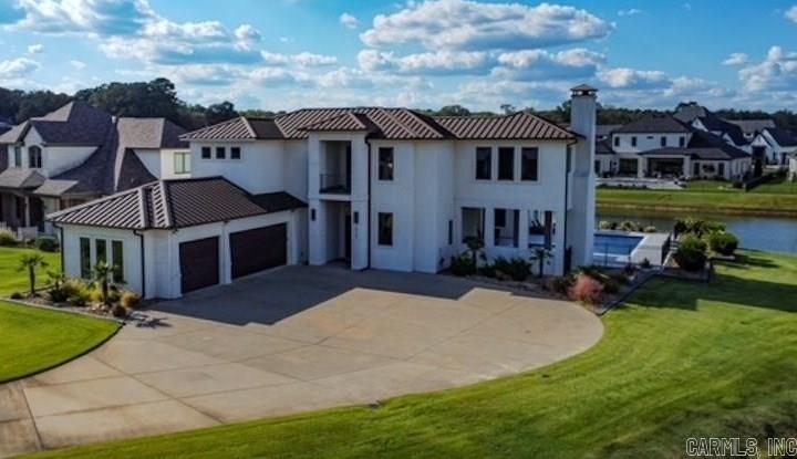 This gorgeous Mediterranean style home offers 4 bedrooms and 4 1/2 baths. Home offers all the latest amenities including tall ceilings, hardwood floors, modern fireplaces inside and out, gorgeous outdoor entertaining area, large media/library room, and gourmet kitchen. Home also includes extra landscaping and custom inground pool with a tanning ledge and water features.