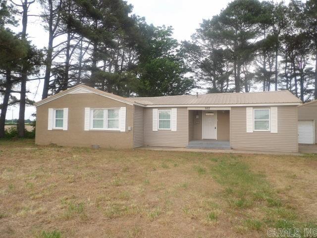 This inviting single-story home offers the perfect blend of simplicity, and rural charm. Set on a spacious lot surrounded by tall pines, the property features a welcoming front porch, low-maintenance exterior, and a durable metal roof. Inside, you'll find a functional layout with an kitchen showcasing white cabinetry, stainless steel appliances, mosaic tile accents, and a window overlooking the backyard. The home's efficient design makes it ideal for first-time buyers, downsizers, or investors seeking a reliable rental in a quiet setting. The large yard provides ample room for outdoor living, gardening, pets, or future improvements. Enjoy the privacy and peaceful atmosphere while still being within a short drive of town conveniences. **see agent remarks