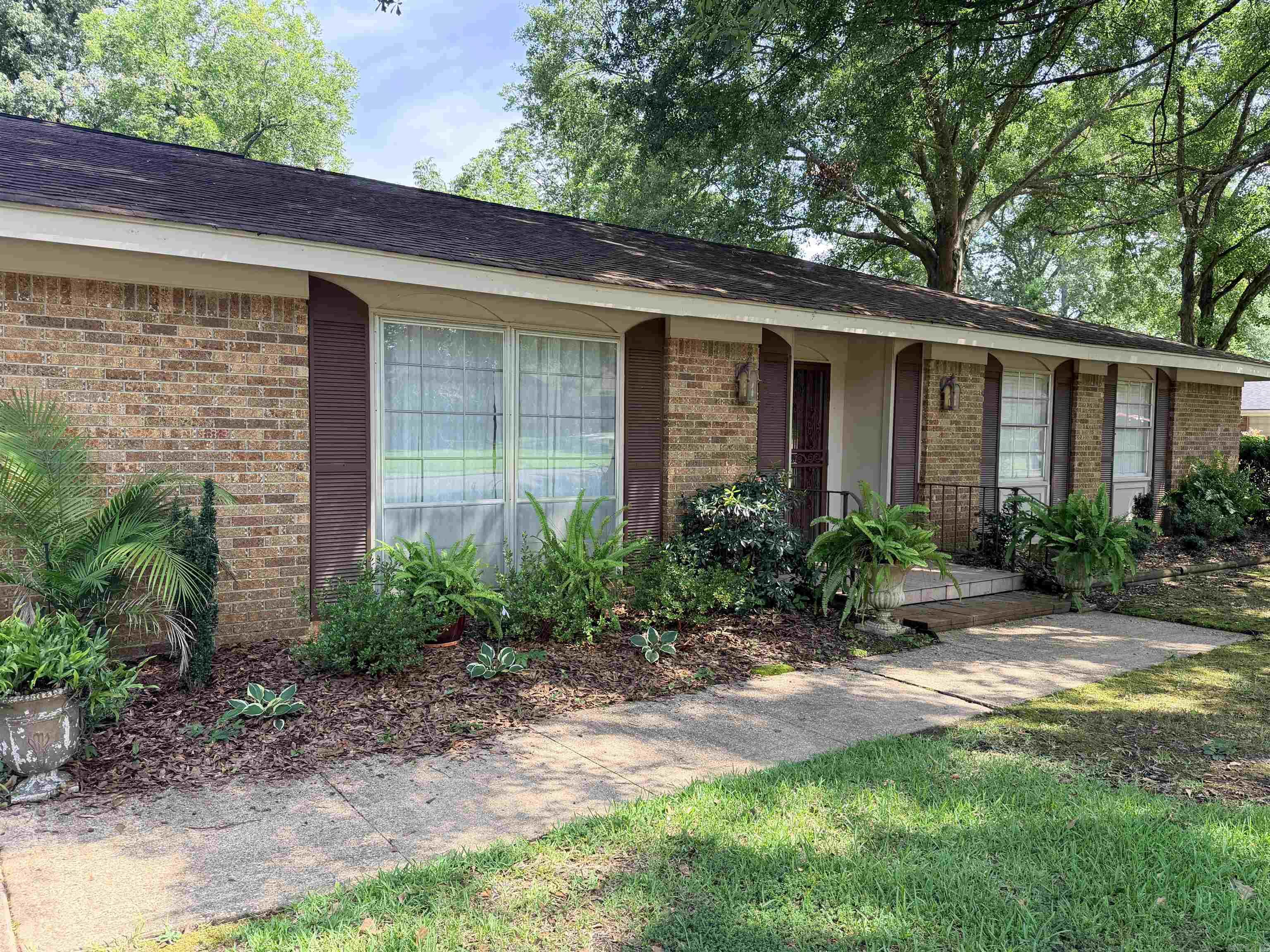 Beutifully updated and in move-in condition, this 4 bedroom / 2 bath home offers ample space to live, entertain and relax! Heated and cooled square footage is approx 2,236. An additional 352 sqft finished sunroom (not currently heated/cooled) with ceramic tile flooring and neutral colors would be a great game room, play room, home office, or additional living space.  Kitchen features updated appliances with induction cooktop and leathered granite countertops. Large utility room offers additional storage and cabinetry with access from garage to sunroom and kitchen. (Both refrigerators will convey.) Formal living/dining space located at the front of the home. Den with gas log fireplace is strategically located at the back of the home.  Architectural shingle roof w/ridge vents installed 2016. Central HVAC installed 2019. Hot water heater replaced 2025. Home is all electric except for gas logs. Fireplace can easily be converted back to wood burning.  Underground electrical service. Wood privacy fence, concrete patio and storage building round out the outdoor amenities.