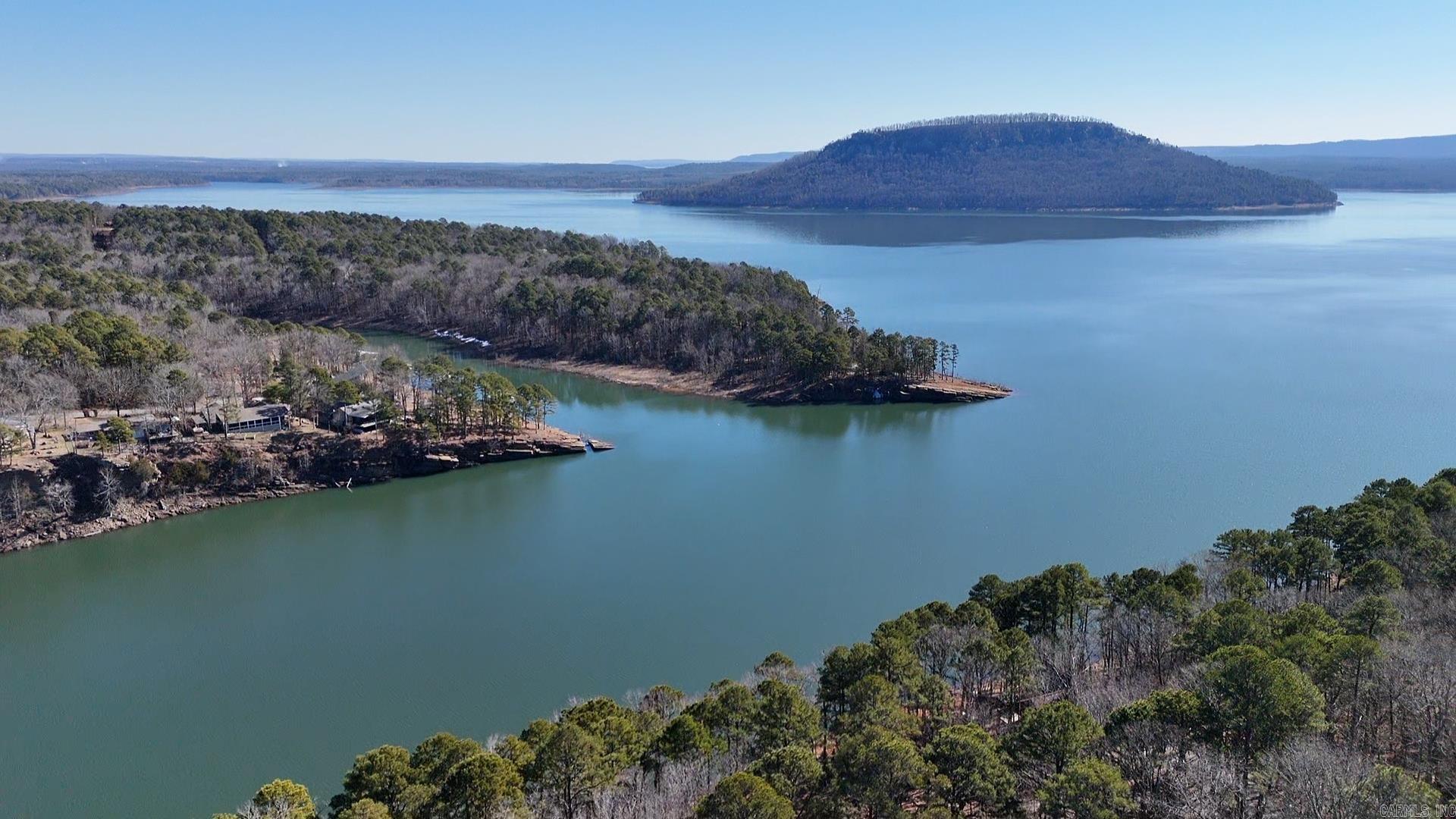 Prime Location, Pristine Condition, Unbeatable Price* Nestled just 1.5 miles from the marina, this exceptional 1.30-acre lakefront lot on Lakeside offers unparalleled access to the serene waters of Greers Ferry Lake. Positioned adjacent to approximately 100 miles of SXS trails, adventure awaits right outside your doorstep. These trails lead to a variety of restaurants, perfect for gatherings with friends and family. **Property Highlights:** **Breathtaking Views:** Enjoy vistas of the iconic Sugar Loaf Island, a renowned landmark rising majestically from the clear waters of Greers Ferry Lake.  - **Natural Beauty:** The lot features stunning large landscape rocks and boulders, providing a picturesque setting for your future home. Imagine building your residence above and possibly adding a deck below to relish the lake, just a few feet away. **Ideal Location:** Proximity to Fairfield Bay's extensive SXS trail system offers endless recreational opportunities, from hiking and biking to dining and socializing.  VISIT FAIRFIELD BAY Experience It Yourself: Take the first step toward making this dream property yours by exploring our virtual tours. Then, contact an agent today!