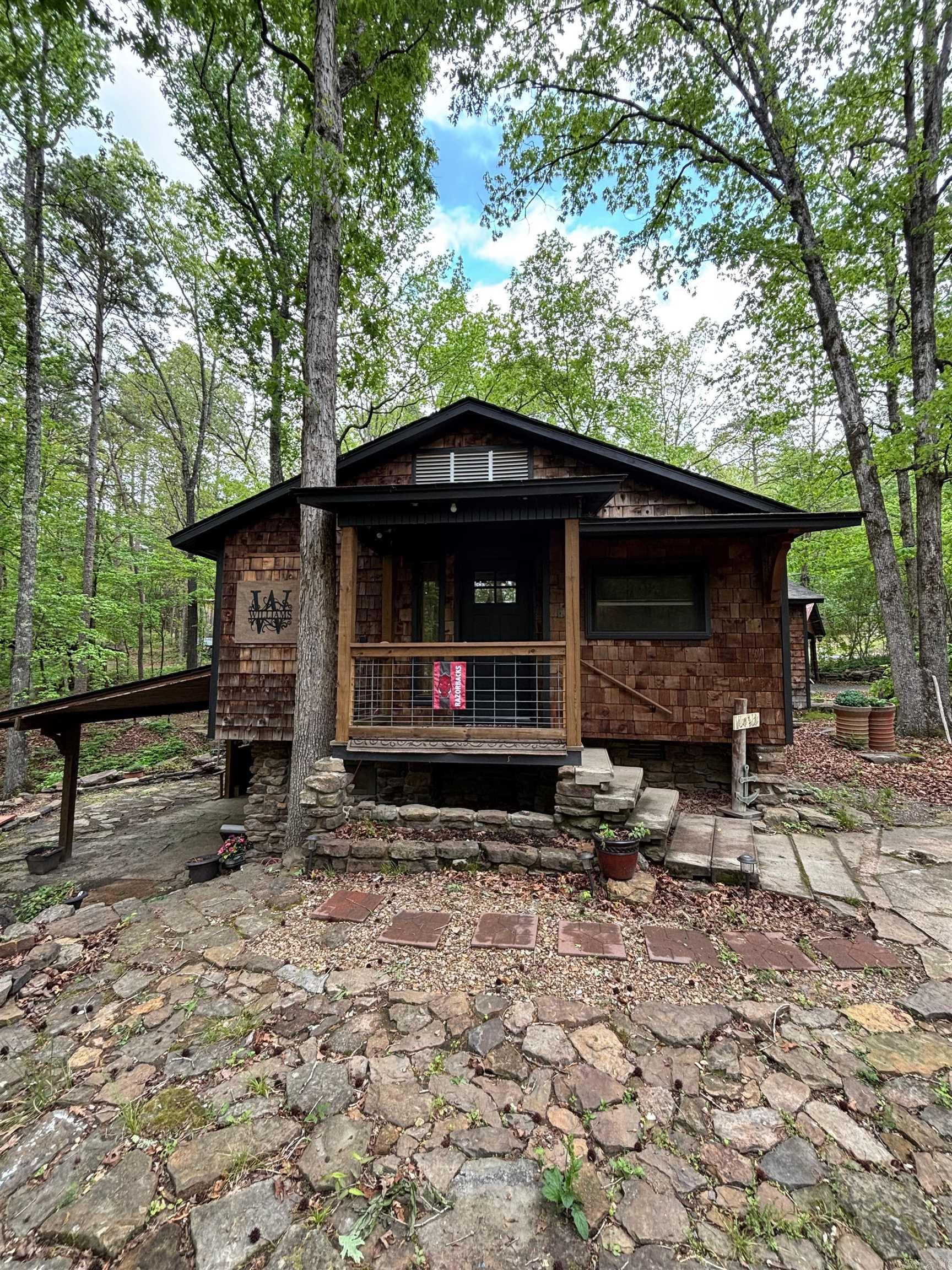 Your Lake Escape Starts Here!  Tucked away in the peaceful beauty of Frontier Canyon, this charming cabin is the kind of place that instantly feels like home… or your perfect getaway.  This 2 bedroom, 2 bath cabin offers 1,168 sq ft of cozy, functional space with a basement for extra room—perfect for guests, storage, or a second living area. Built in 1996, but thoughtfully maintained with a roof and HVAC system just 3 years old, giving you peace of mind for years to come.   A private 6-foot wide maintained trail that leads you straight from your property down to the lake. Imagine morning walks to the water, evening sunsets, and easy access whenever you want it.  And just when you think it couldn't get better.... A beautiful creek runs through the property, adding that peaceful, nature filled setting everyone is looking for.  The boat launch is just ONE minute away, making lake days effortless and spontaneous.  Plus, you'll have ample storage with a shop and shed on the property giving you space to store your lake toys, tools, and more.  Whether you’re looking for a weekend retreat, full-time lake living, or an investment opportunity—this one checks all the boxes.