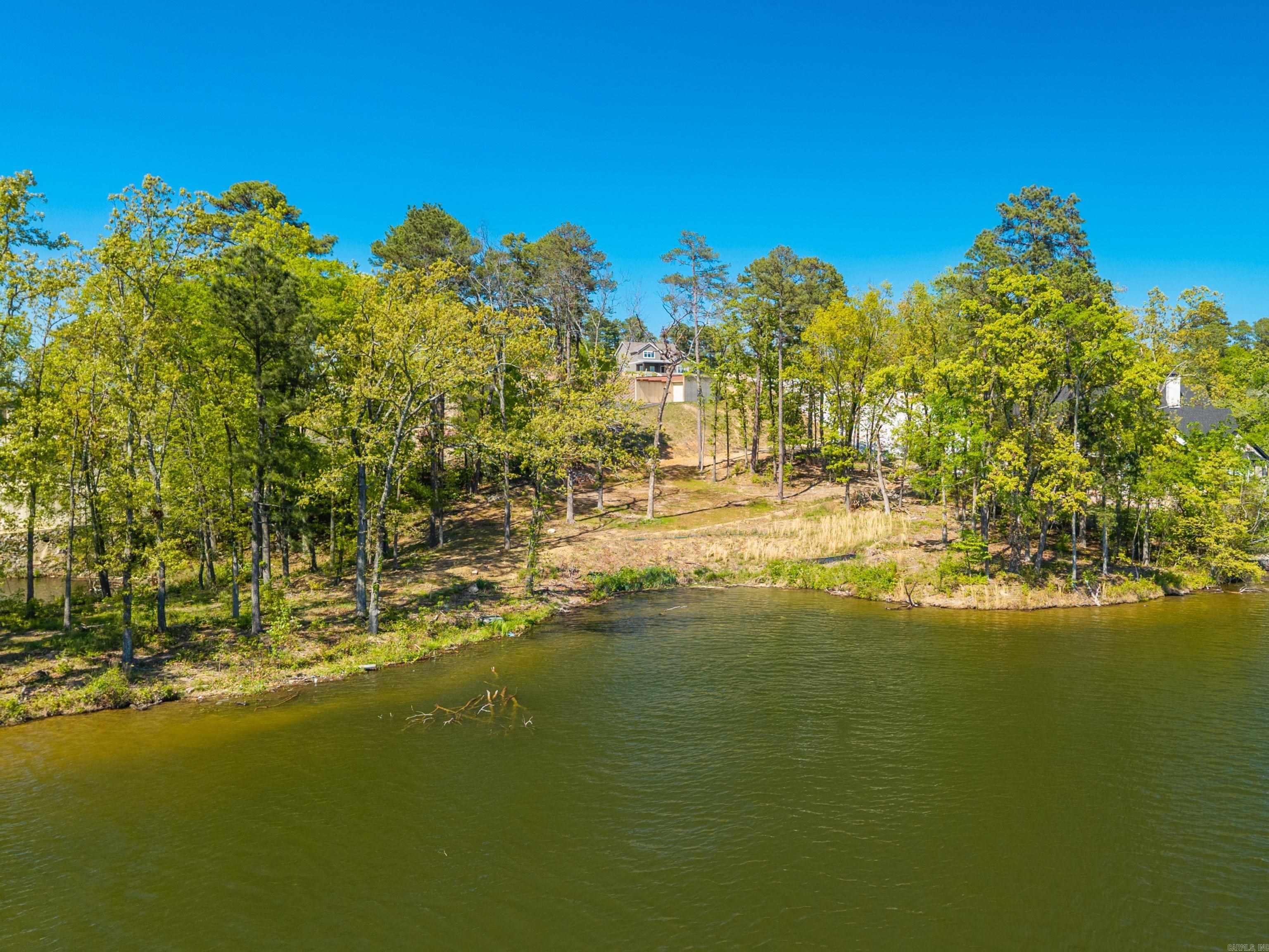Prime piece of lakefront real estate available for the first time since the 30s. With 1.817 acres, approximately 668 feet of frontage on the much sought after area of Lake Hamilton, and a spectacular lake and mountain view, you could build the oasis of your dreams! Check out the virtual tour for a video of the drive down to the private building spot which already has conduits in place from source of utilities saving you an extra expense. Zoned for either single family residence or multi family, making it a great place for vacation homes as well as a private residence. Only a few minutes away from the bypass, this is a great central location close to hospitals, shopping, dining and all of the wonderful entertainment Hot Springs has to offer. Beautiful sunsets await you on this truly GRAND point. Don't let this one slip away!