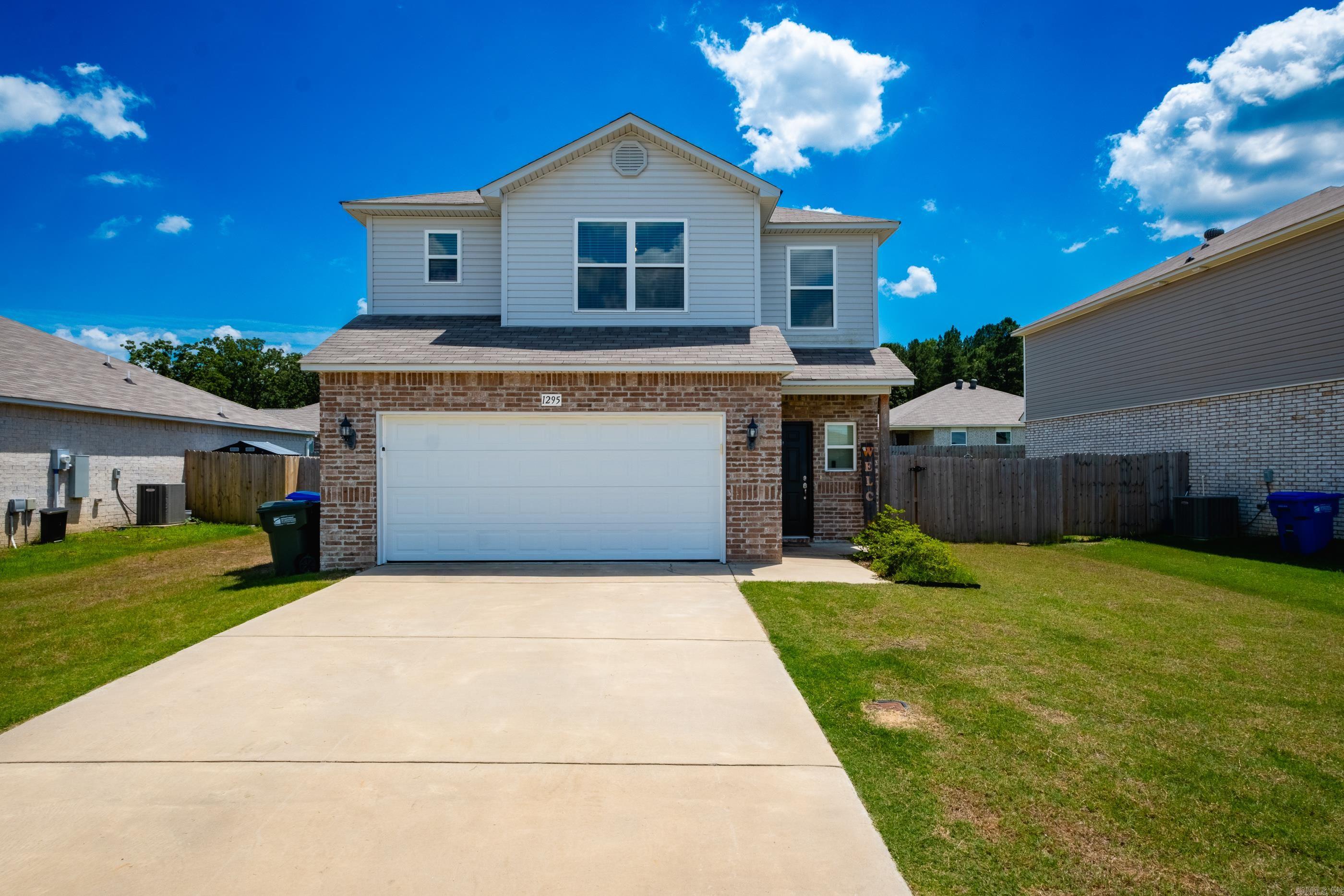 Built in 2022, this adorable two-story home offers modern style, thoughtful upgrades, and the convenience of Conway Corp utilities. Ideally located just minutes from I-40, Dave Ward Drive, shopping, restaurants, and the University of Central Arkansas, you'll enjoy easy access to everything Conway has to offer. Step inside to an inviting open-concept living area featuring an electric fireplace and abundant natural light. The kitchen is designed for both everyday living and entertaining with an island/breakfast bar, pantry, and dining area overlooking the backyard. A convenient half bath completes the main level. Upstairs, you'll find three spacious bedrooms, two full baths, a versatile bonus area perfect for a home office or playroom, and an upstairs laundry. Ample closet space provides plenty of storage. This move-in ready home combines comfort, convenience, and modern living! Agents, See Remarks.