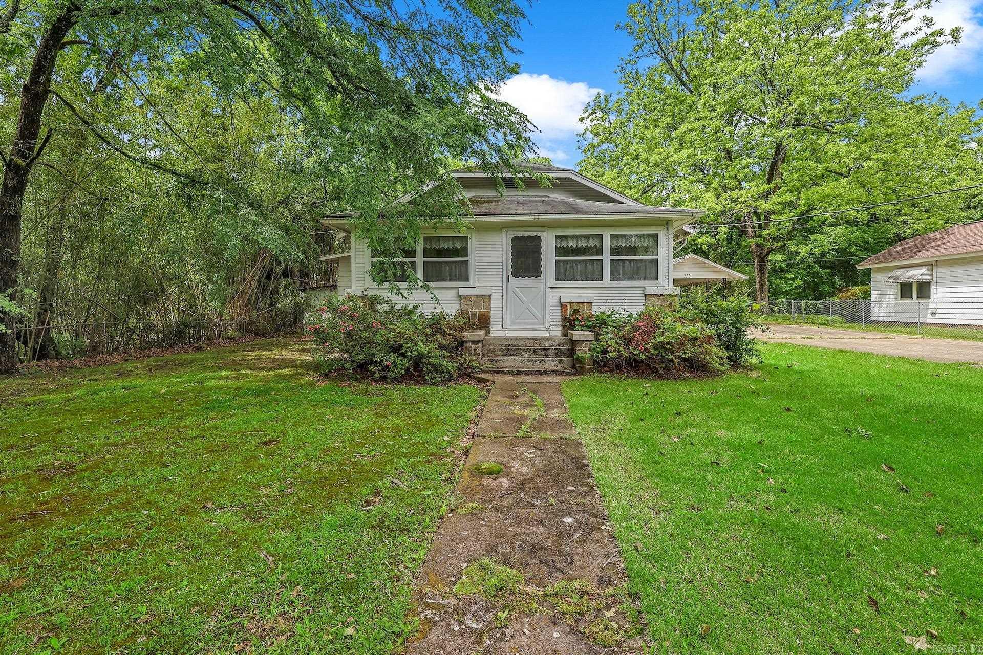 Step into the charm of this 1930-built 2 bedroom, 2 bath home located in the heart of Mount Ida. Full of character, this property offers a welcoming front sunporch—perfect for morning coffee—and a cozy rear sunroom to enjoy year-round views of the backyard. Inside, you’ll find classic details that reflect the home’s era, along with a functional layout ready for your personal touch.  The property includes a fenced backyard, carport, and two outbuildings providing additional storage or workspace. While the home could benefit from some updates, it presents a great opportunity to enhance and make it your own while preserving its original charm.  Whether you’re looking for a full-time residence, investment opportunity, or a project with personality, this one is worth a look.