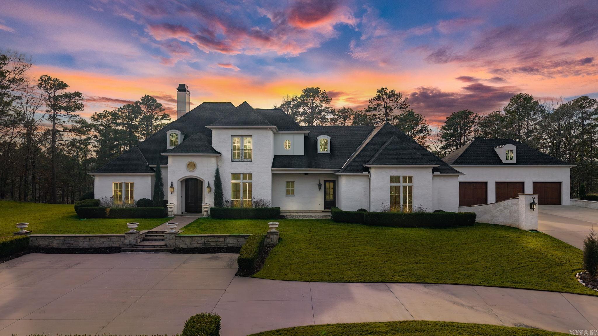 Breathtaking custom home set atop a stunning 5.5AC mountaintop setting offering privacy, views, and exceptional indoor and outdoor living. Designed with both elegance and function in mind, the home flows effortlessly thru-out. The gourmet kitchen features Thermador appliances, handcrafted island accents, and generous cabinetry, opening to inviting living spaces with a fireplace and wall of windows overlooking the landscaped grounds. The main level primary suite is privately positioned with two closets and a refined bath, while two guest bedrooms share a jack and jill bath. Upstairs offers two additional guest bedrooms and a spacious bath. The current owners have made enhancements, including adding an impressive family room with fireplace, custom built-ins, and access to a 420sf home gym/4th garage bay. An oversized detached three car garage was added with a 440sf bonus room and storage. Outdoor living is exceptional with an in ground pool and a beautifully designed 735sf pool house offering a 580sf covered patio with fireplace, grill, and hot tub, plus a kitchenette, full bath, stacked laundry, and flexible living/sleeping space. Main house 4918sf +1585sf additional.  Come see!