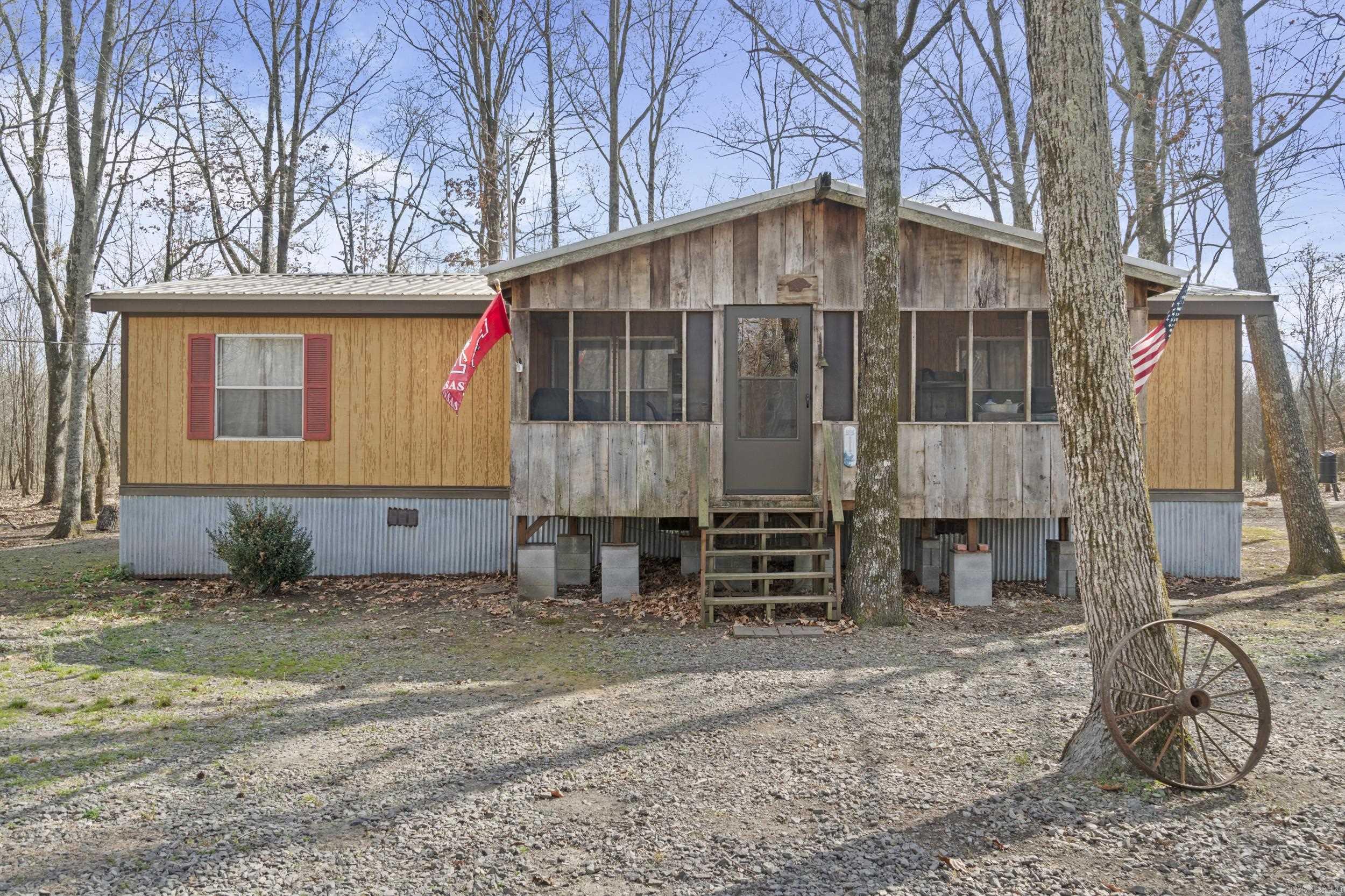 This NIMMO HUNTING/FISHING CABIN just might be THE place for you. Being sold FULLY FURNISHED, with warm rustic interior on 4 lots with a 24 x 56 HUGE Shop! Experience the charm of riverside living with this UNIQUE RETREAT, perfect for country living or a peaceful getaway. The property features a cozy fireplace, walk-in closets, and magnificent views from the back porch. Enjoy sitting around the fire pit, or reading on the screened in front porch! Situated at the end of a quiet street with a shop waiting to store your boats, ATVs, and more. Nimmo Boat Access to the Little Red River only a short drive away. Enjoy the convenient access to Hurricane Lake WMA and Raft Creek WMA. This property would make a perfect vacation rental too! The home is on city water, has a septic system and has central heat and air.