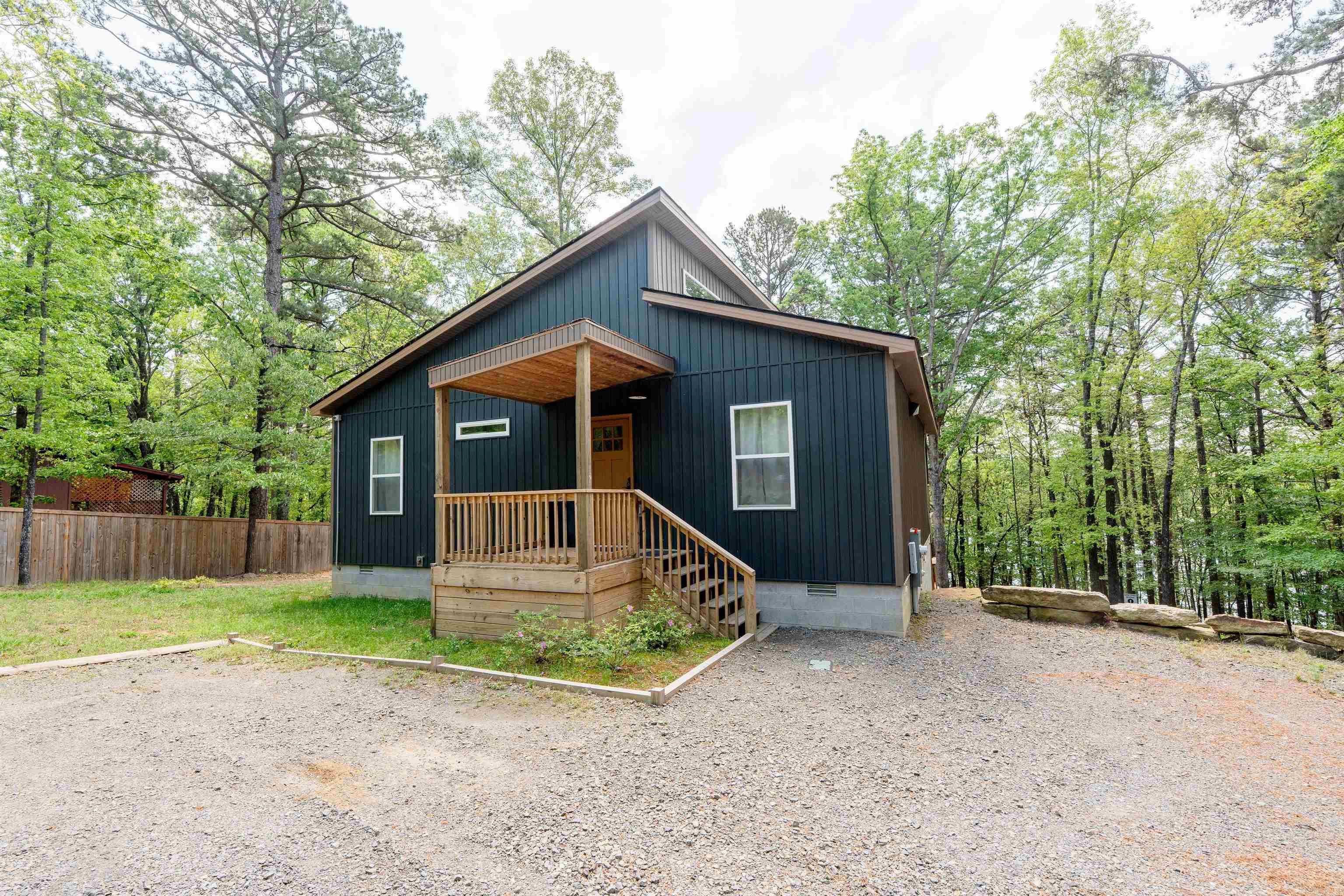 Lakefront, lake view, and lake access! Charming 3BR/2BA home with loft on Greers Ferry Lake. Fully furnished and turn-key—ideal as a vacation getaway, full-time residence, or income-producing short-term rental. Open floor plan with vaulted ceilings and abundant natural light. Spacious loft offers additional sleeping or flexible living space. Kitchen features hard-surface countertops, ample cabinetry, and a large island for entertaining. Cozy fireplace in the main living area. Expansive deck with hot tub, perfect for outdoor living and guest enjoyment. Gentle walking trail provides easy access to the lake. Bonus RV hookup adds extra convenience for owners or guests. Strong potential for nightly rental income in a desirable lake area.
