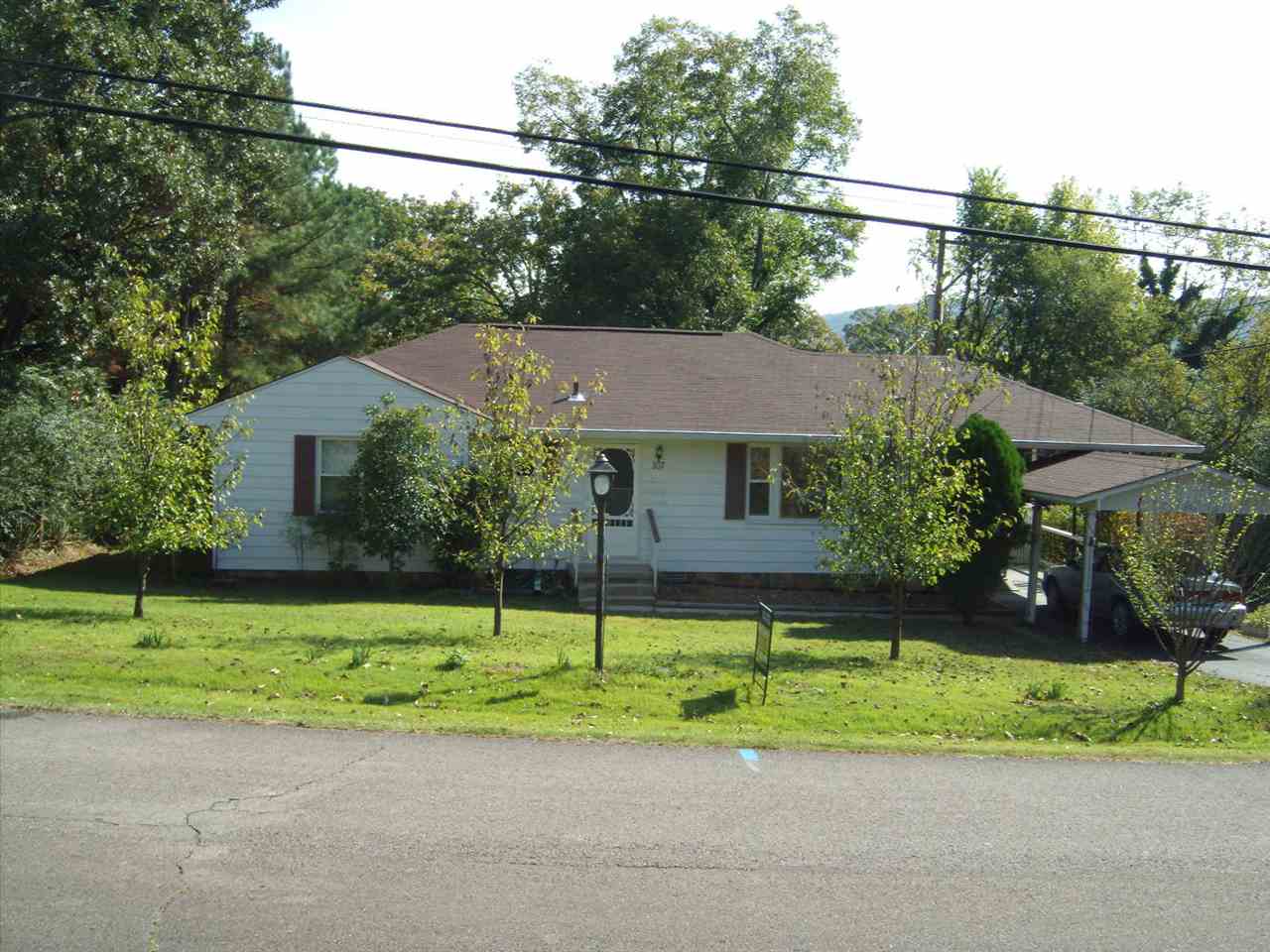This home is move in ready, clean & well maintained, vinyl siding, gutters, newer roof, vinyl windows, hardwood & carpet floors, storm doors, carport attached & metal carport detached, storm shelter, workshop with lean-to sheds, storage under the home, nice landscape yard, shade trees, chain link fenced yard, elbow room on 3 lots, you can walk to church, grocery store, city park or down town.