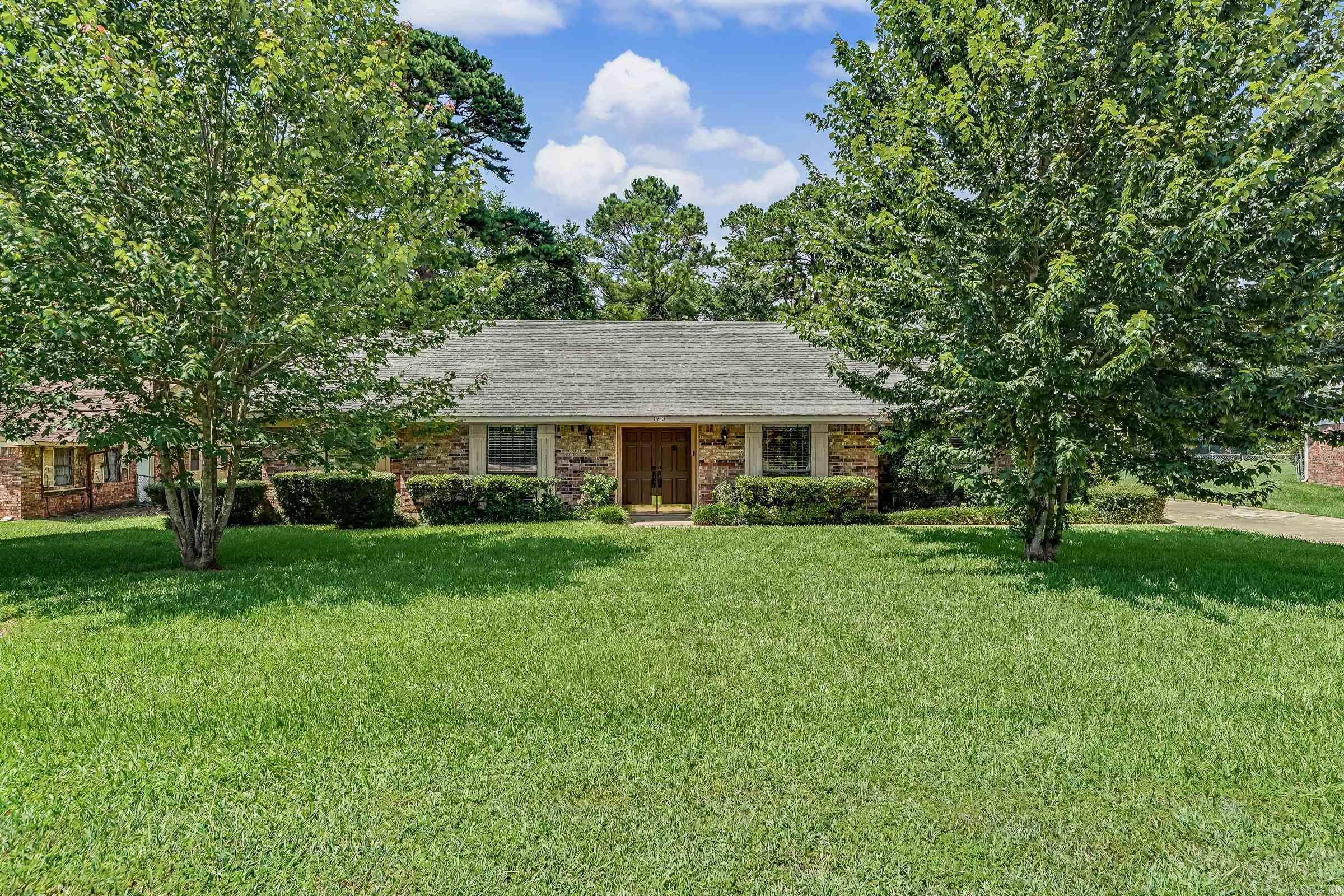 Beautiful 4-bedroom, 3-bath brick home offering 2,394 square feet of spacious living designed for both everyday comfort and entertaining. The updated kitchen features custom wood cabinetry, tile backsplash, a large island, and abundant storage, all opening to the expansive living area with a stunning brick fireplace. The spacious primary suite offers custom built-ins, double vanities, and a beautifully tiled walk-in shower. Generously sized secondary bedrooms, a large laundry room with ample cabinetry, and multiple living spaces provide room for everyone. Step outside to your own private retreat featuring an in-ground swimming pool, pool house/cabana, covered entertaining area, fenced backyard, and covered RV or boat parking. Mature landscaping and exceptional curb appeal complete this one-of-a-kind property. Combining over 2,300 square feet of living space with incredible indoor and outdoor amenities, this home is ready for its next owners. Schedule your private showing today!