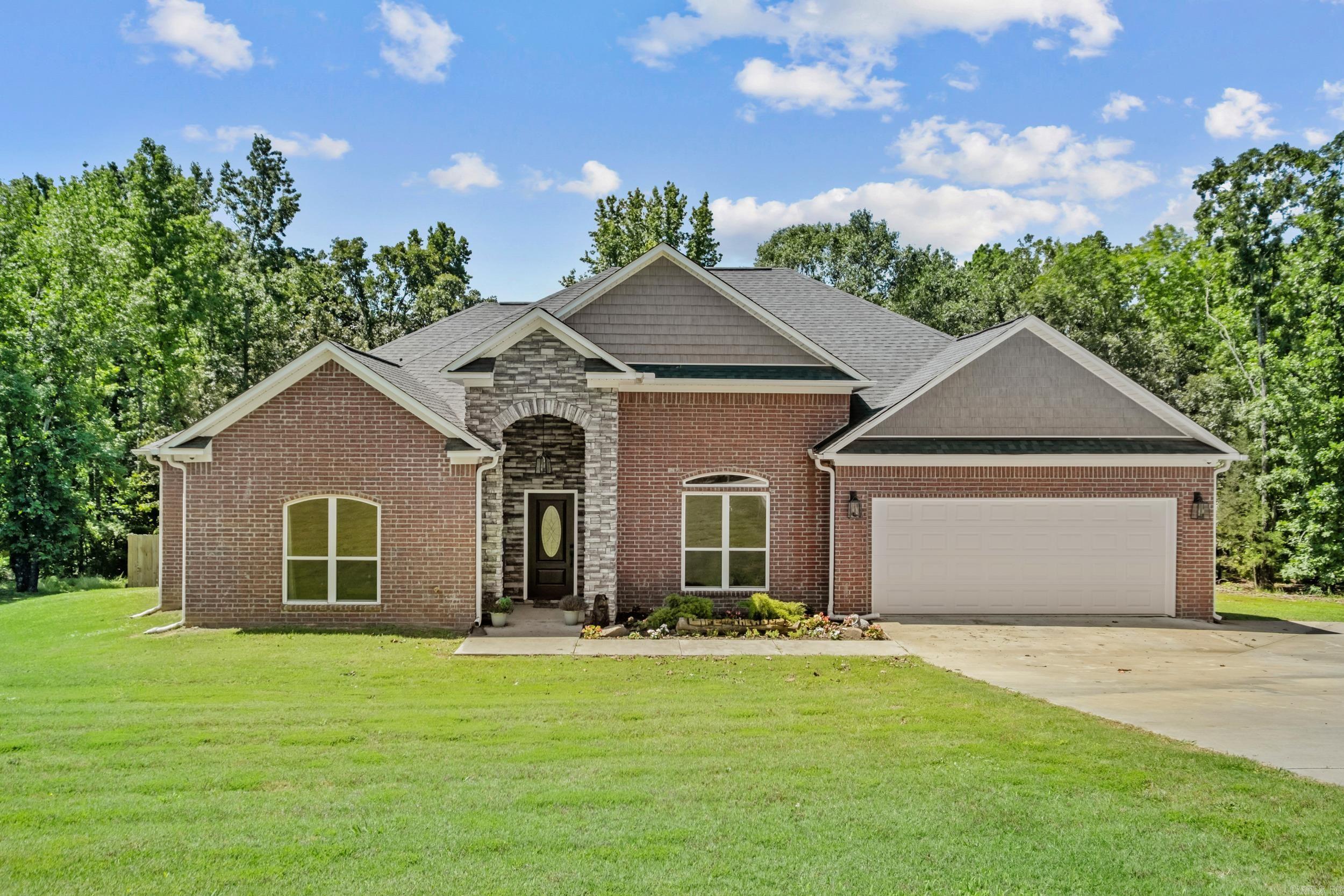 Looking for your slice of elegance just outside city living? This stunning all-brick home with a rock-accented entry offers the perfect blend of style, space, and comfort.  Step inside to an inviting open-concept floor plan, ideal for both everyday living and entertaining. To the left, you’ll find three generously sized bedrooms, perfect for a growing family, guests, or a home office setup.  The home features a spacious primary suite complete with a large walk-in closet, providing a private retreat at the end of the day. You’ll also love the oversized laundry room with a folding area, adding convenience and functionality.  Out back, enjoy a fenced-in yard—perfect for kids and pets—along with a peaceful wet-weather creek that adds natural charm to the property. As an added bonus, you’ll have access to the neighborhood lake, recently stocked, making it a great spot for relaxation and recreation.  Don’t miss your chance to see this beautiful home—schedule your showing today!  Agents, please see remarks.