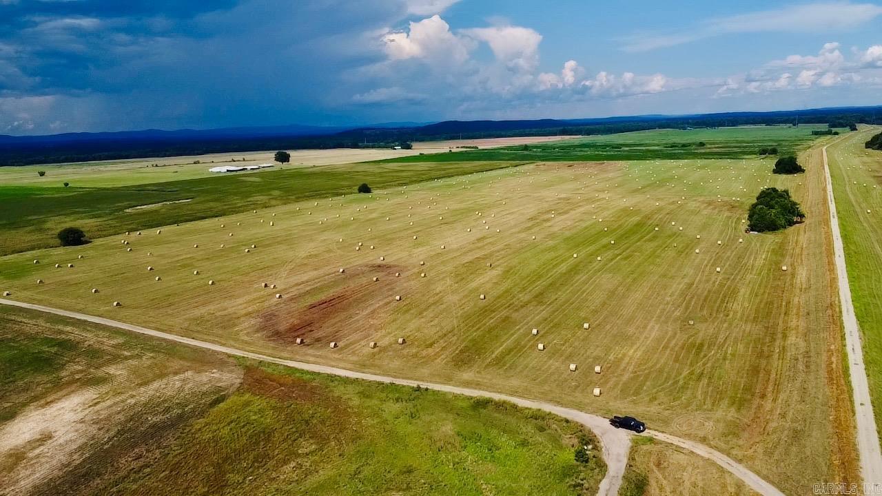 Exceptional 35+ acre tract of productive, level land offering endless possibilities! This beautiful property is well-suited for hay production, cattle, horses, or other agricultural uses. The land is primarily flat, usable pasture and typically produces approximately 140 round bales of hay each cutting up to four (4) times a year, making it an excellent investment for farming or ranching.  With ample space to build your dream home while maintaining a working farm, this property offers the perfect blend of productivity and country living. Whether you’re looking to expand your agricultural operation, establish a livestock farm, or enjoy peaceful rural acreage, this property is ready for your vision.  Don’t miss this opportunity to own a productive piece of Arkansas farmland with outstanding potential!
