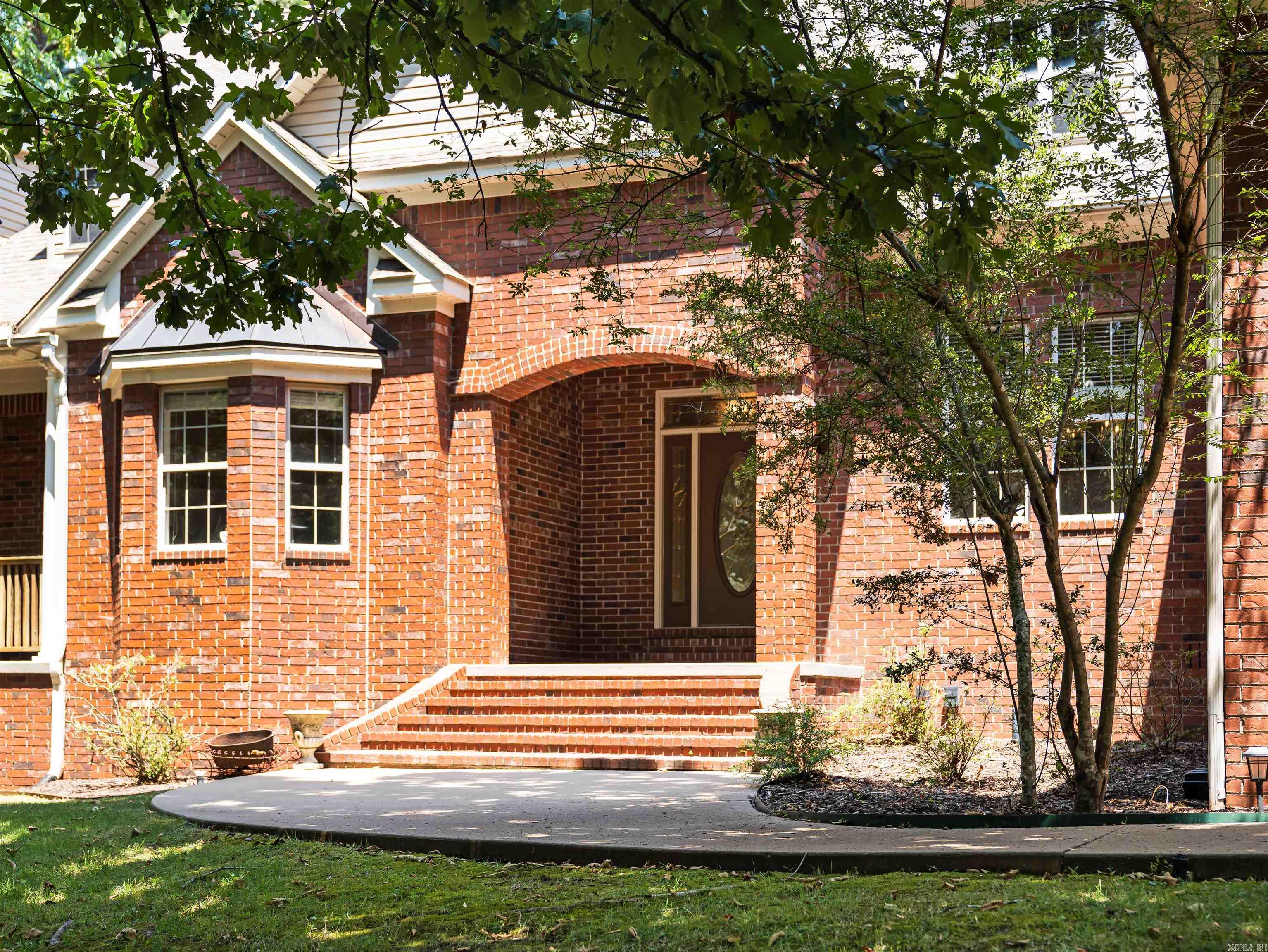 Nestled on a sprawling wooded lot at the end of a quiet cul-de-sac, this classic brick residence combines timeless traditional architecture with warm, light-filled living spaces. The impressive exterior features manicured lawns, mature shade trees, and an extended driveway leading to a spacious three-car garage. Around back, a large covered porch overlooks a fenced in backyard--ideal for outdoor entertaining or relaxing against the tranquil forest backdrop.  The main level offers an expansive open flow between formal and casual living areas, including a cozy hearth room centered around a brick fireplace. The kitchen is outfitted with custom warm-wood cabinetry, an abundance of counter space, a walk-in pantry, and stainless steel appliances. With generous bedrooms, bright neutral finishes, well-appointed bathrooms, plus a whole-home generator, this property effortlessly blends luxury, space, and functionality. Schedule your tour today!