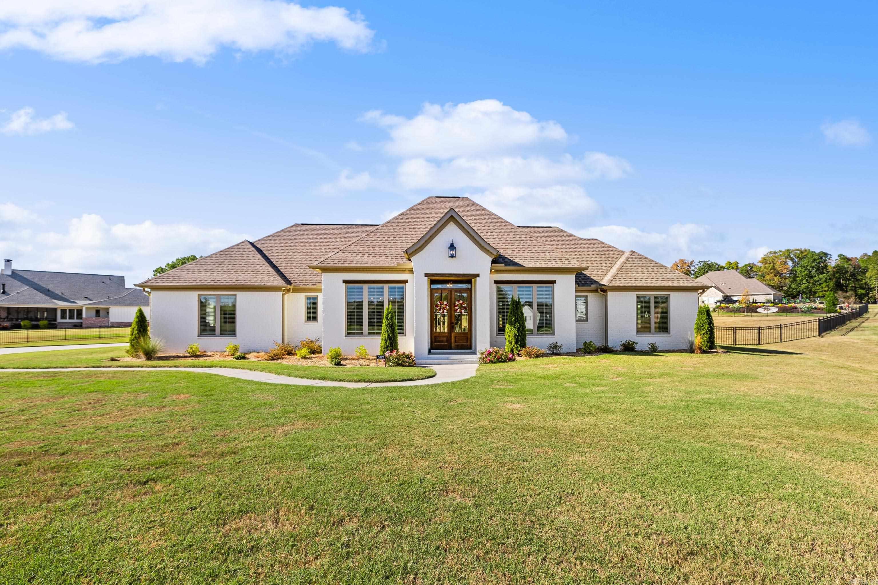 ONE LEVEL CUSTOM HOME ON 1.39 ACRE LOT IN THE STABLES! This custom built home features 2 primary suites on separate ends of the home, complete with walk-in closets and custom tile showers. The open kitchen features a spacious island with breakfast bar, gas range, timeless finishes, and a massive walk-in Butler’s pantry. The living room includes wood detail on the ceiling and built-ins with a very unique window seat, creating a cozy feel for all your guests. The designated office has 12 ft ceilings, built-ins and a barn door, making working from home a delight. The main primary suite is flooded with natural light and includes a tray ceiling and drop down vanity in the bathroom. Wood style ceramic tile floors adorn the majority of the home and a large laundry and mudroom make organization a cinch. A beautiful covered back porch features a gas fireplace and opens to a fenced back yard that is ready for your pets, kids or pool! Gated community in Bryant Schools!