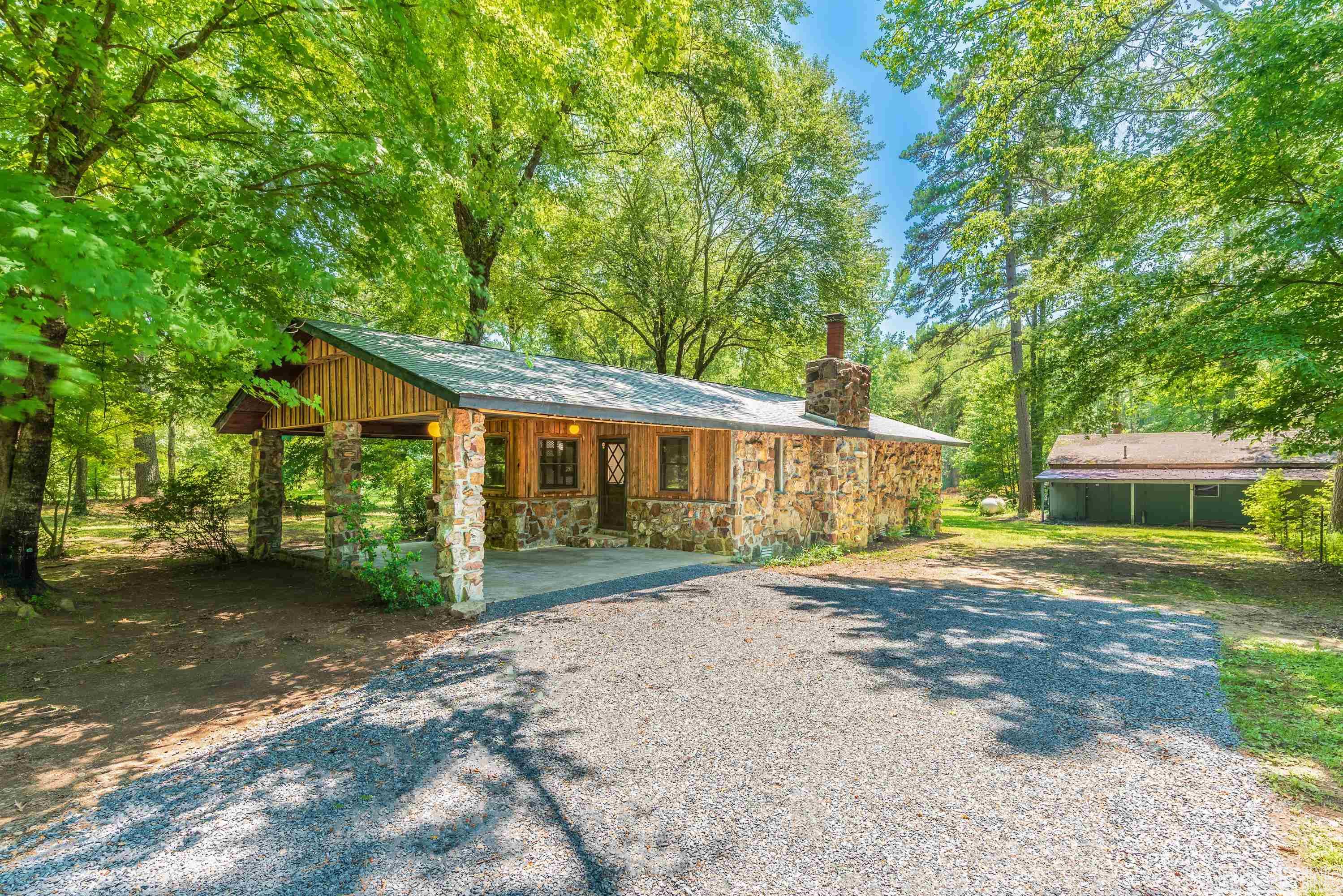 Completely remodeled home by the lake! New kitchen/bath, renovated hardwood floors in living/dining/master, new granite countertops and cabinets throughout. ALL NEW appliances with gas range, added attic fan/insulation, NEW ROOF, LVP flooring. Rock fireplace with blower, cypress plank accent wall along with cypress faux ceiling beams and trim. New electrical fixtures switches and receptacles, new plumbing and faucets, new deck, new fascia boards & stained, cypress board & batten exterior with native stone rock.24X32 shop with lean-to on both sides. ONLY 2.2 MILES TO SUGARLOAF MARINA!