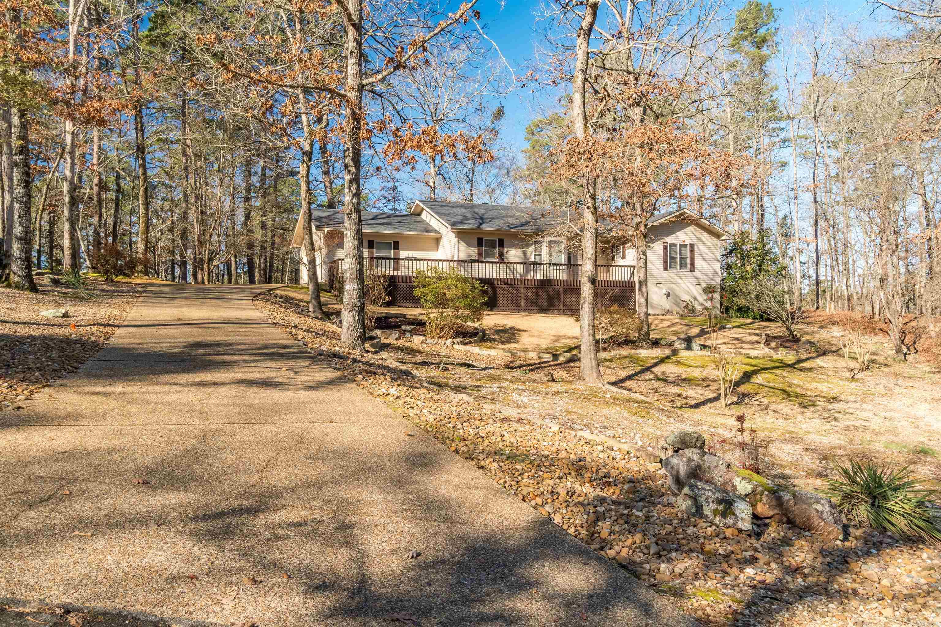 Peaceful Cul-de-Sac Gem with Resort Amenities Experience the best of Hot Springs Village in this meticulously maintained, single-story home. Nestled on a quiet cul-de-sac in the Gancho subdivision, this property offers a turnkey lifestyle perfect for those seeking tranquility. Enjoy your morning coffee on the large private deck or unwind in the whirlpool spa. With over 2,000 sq. ft. of living space, including a flexible office space and a bright Arkansas room, there is plenty of room to relax and entertain.The open-concept kitchen with a breakfast bar flows seamlessly into the dining area. Significant value is found in the functional layout, tray ceilings, and crown molding as well as the granite countertops, new light fixtures and fresh paint.  The owners suite has a mounted TV that stays, Kitchen refrigerator, washer and dryer stay, this home is move-in ready!! The Office can easily be a third bedroom.  Residents enjoy exclusive access to world-class golf, tennis, and fitness facilities within this secure gated community. Don't miss the Dog run, Partially fenced yard and sink in the laundry room.  Must see!!!