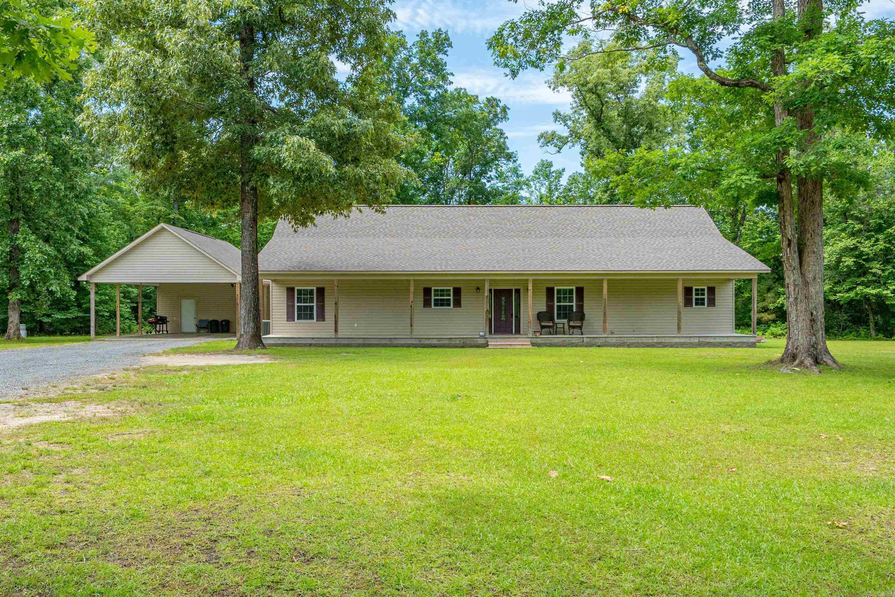 Spacious 3 bedroom 3 bath home sitting on 10.23 acres with mature trees, overlooking a beautiful, stocked pond.  This is a must see retreat within 5 minutes of Arkadelphia amenities.  Split floorplan with open concept home featuring vaulted ceilings in family area, large laundry room off primary ensuite, amazing views from front and back porches.  Additionally, this property features a 35x50 shop with a 600 sf 1 bedroom 1 bath, efficiency apartment.  The property is stunning for entertaining, fishing, gardening, other outdoor activites or simply enjoying the view.