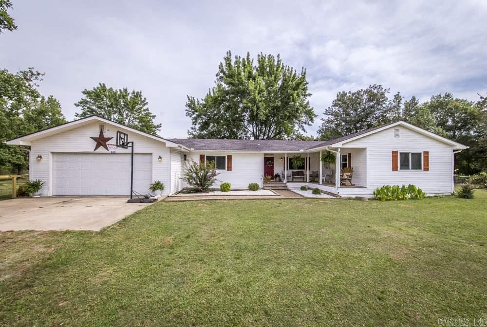 Country charmer and horse property at its finest.  Beautiful three acres completely fenced and ready for you horses or cattle.  Barn, raised garden area, porch, covered patio area. Inside you will find an open floor plan with wood flooring, good size rooms, separate laundry room, walk in closets.  New paint and beautiful pallet accent wall in the living room.  Don't miss this one located near shopping and schools.