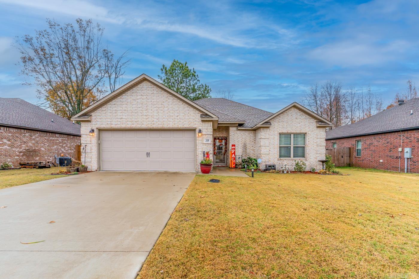 Welcome Home to 139 Brookvale Circle in Brookland, AR!! This charming 3 bedroom, 2 bathroom residence offers a perfect blend of comfort and style. Step inside and be greeted by a bright and spacious living area, perfect for entertaining. The gas fireplace is the focal point of this beautiful room. The open kitchen and dining makes meal preparation a joy. The master suite is a true retreat! The primary bathroom features double sinks and double closets! The additional two bedrooms are generously sized, providing flexibility for any of your needs. Relax and unwind in your screened in patio in your private backyard oasis, perfect for morning coffee, fall bonfires, and summer barbeques. Don't miss your chance to make this house your home! Schedule a showing today!