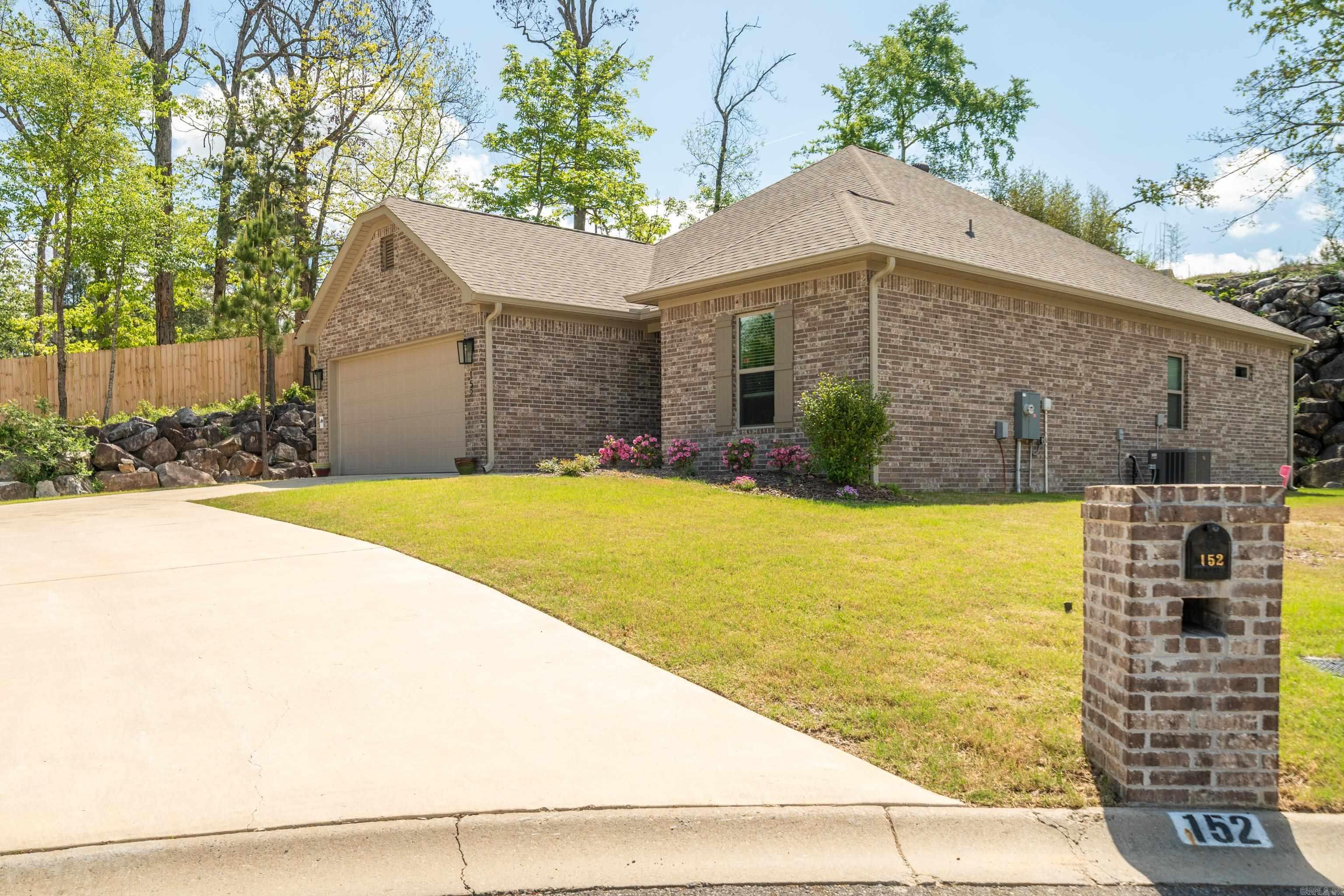 Welcome home to Forest Lakes subdivision in Hot Springs, this thoughtfully designed single-level home offers 3 bedrooms, 2 baths, and 1,655 SQFT of effortless living. The open layout is elevated by custom cabinetry, solid surface countertops, and luxury vinyl plank flooring throughout. A stylish electric fireplace anchors the living space, while the primary suite features a soaking tub and separate shower for a true retreat feel. Complete with a covered patio, sprinkler system, architectural roof, and 2-car garage, this home blends comfort, function, and polished design in a prime location. Schedule your private showing today—contact me or your preferred real estate professional to experience this home in person.