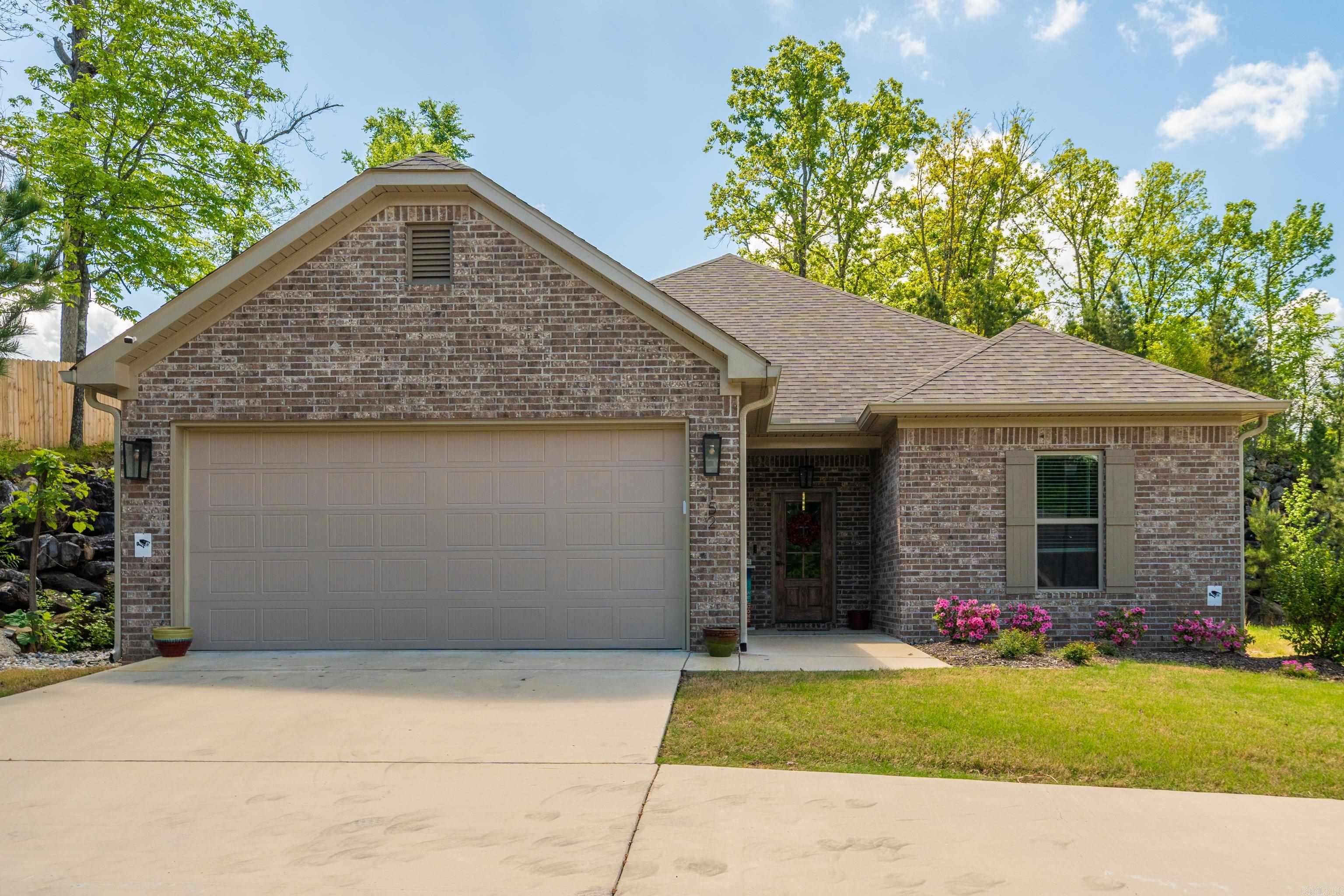 Welcome home to Forest Lakes subdivision, a 55+ community in Hot Springs, this thoughtfully designed single-level home offers 3 bedrooms, 2 baths, and 1,655 SQFT of effortless living. The open layout is elevated by custom cabinetry, solid surface countertops, and luxury vinyl plank flooring throughout. A stylish electric fireplace anchors the living space, while the primary suite features a soaking tub and separate shower for a true retreat feel. Complete with a covered patio, sprinkler system, architectural roof, and 2-car garage, this home blends comfort, function, and polished design in a prime location. Schedule your private showing today—contact me or your preferred real estate professional to experience this home in person.
