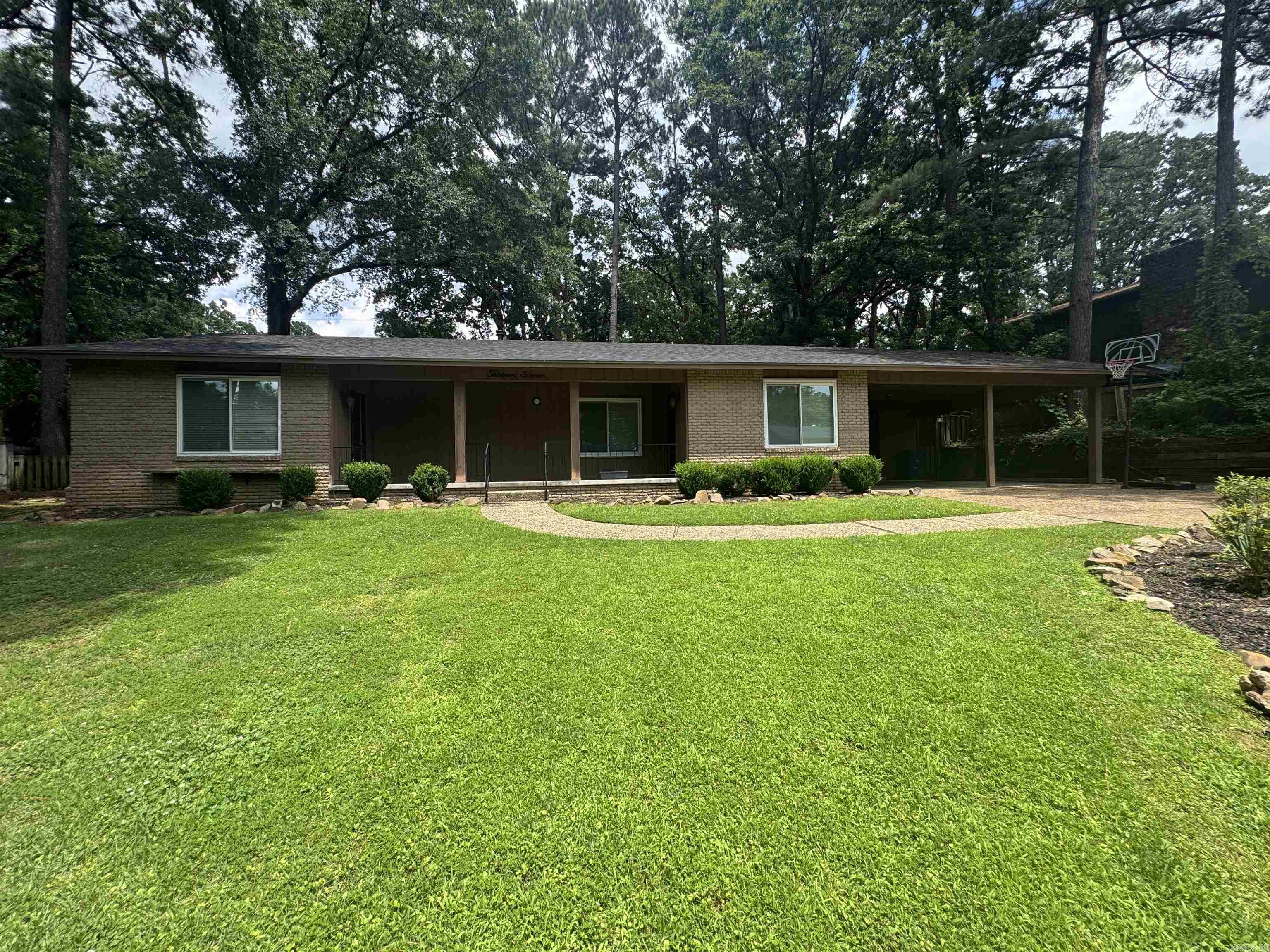 Beautifully updated home in desirable Park Hill! Sits on a spacious +/- 3rd acre lot shaded by mature trees enhanced by attractive landscaping. Inside, you'll find beautiful hardwood floors, two living areas, large fireplace, built-in bookshelves, an updated kitchen, updated primary bathroom, a large laundry room, and abundant storage throughout. Enjoy relaxing on the covered front porch or entertaining on the private, shaded backyard patio. The lush Zoysia lawn is supported by a sprinkler system, and the quality site-built shed provides excellent space for a workshop, craft room, hobby area, or man cave. Major improvements include an architectural shingle roof installed just two years ago and a newer driveway. Located on a quiet, low-traffic street with convenient access to shopping, dining, downtown and interstate. This move-in ready home offers the perfect combination of privacy, comfort and convenience. **Agents See Remarks**