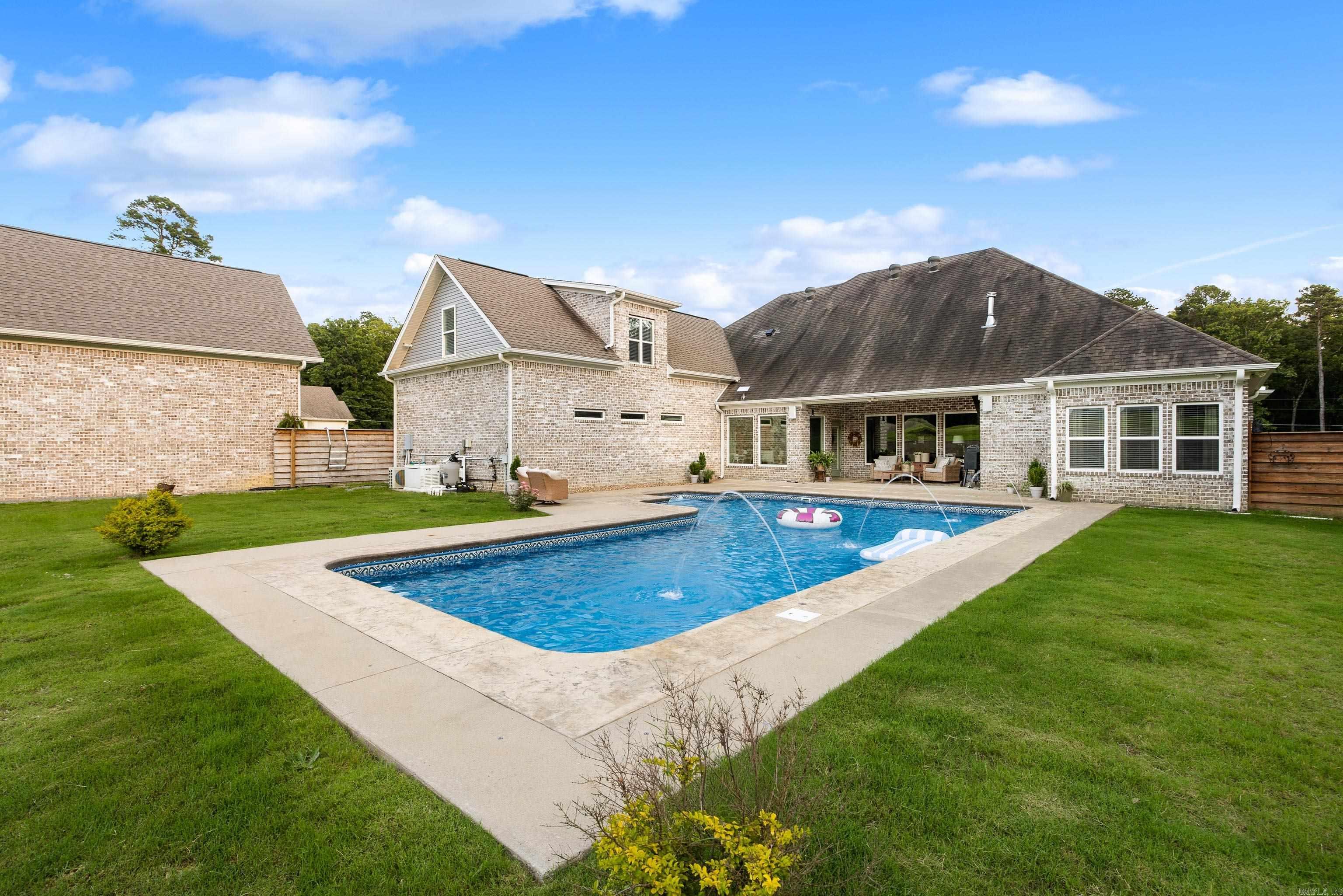 Welcome to 3506 Brock Rd in Alexander—an exceptional estate set on 2.5 private acres, offering refined living, resort-style amenities, and unmatched garage and shop space, all just minutes from Benton, Bryant, and Little Rock. This 4-bed, 2.5-bath residence showcases a thoughtfully designed layout filled with natural light, expansive living areas, and timeless elegance. A private bonus room above the garage provides versatile space for a home office, media lounge, or guest retreat. Outdoors, enjoy a private swimming pool ideal for relaxing or entertaining, surrounded by manicured grounds with room to expand. Car enthusiasts and hobbyists will appreciate the three-car attached garage, detached two-car garage, 35x70 shop, and additional 35x35 shop—perfect for storage, projects, or business use. A rare blend of luxury, privacy, and versatility, this well-appointed home offers comfort, functionality, and ease of ownership. The generous acreage allows for curated outdoor living, recreation, or future enhancements. Enjoy a peaceful, private setting with convenient access to shopping, dining, and major commuter routes. An ideal property for those seeking space to live, work, and store it