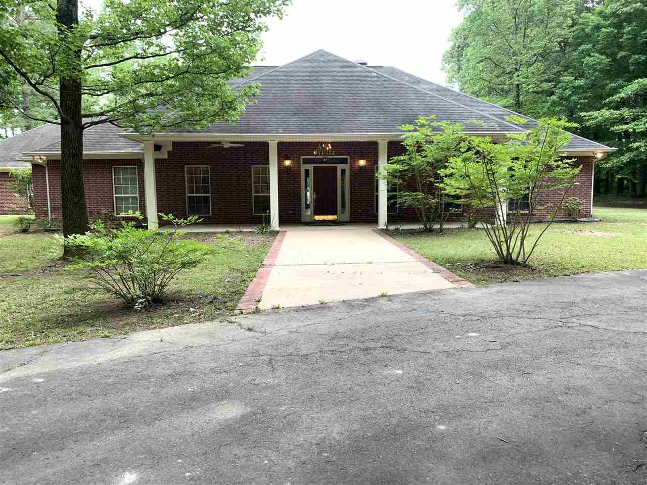 Beautiful custom built brick home on 20 acres with shop with full bath,  barn, pond, inground pool, gun closet, three car garage, central vac system and beautiful millwork, large pantry and laundry room.