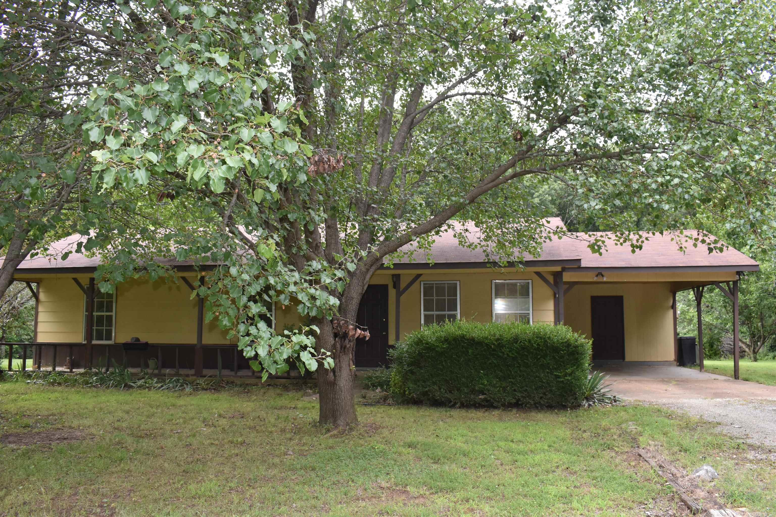 2 1/2 acres located on a secluded beautiful lot. Fruit trees, flowers of all types throughout the yard, room for a large garden, many shade trees! This 3 bedroom, 1 1/2 bath home is awaiting it's new owner. Kitchen, dining & living room are all open - perfect for entertaining. One car carport with storage at the end of the carport as well as a large storage building. If you are looking for acreage and privacy you will love this well insulated home. House sold as is.