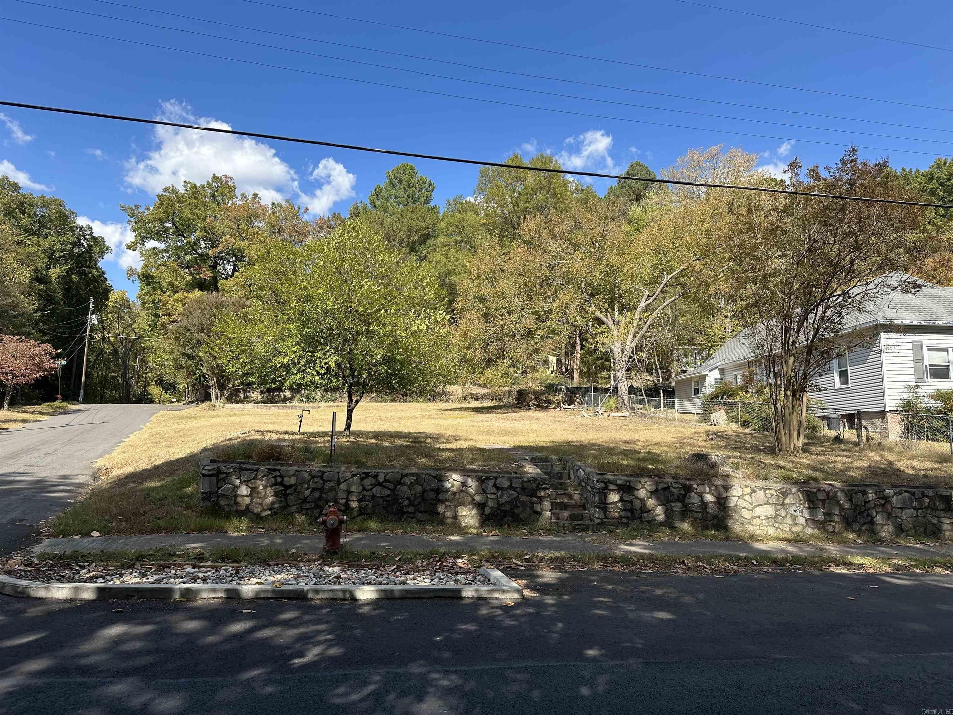 Quality location!! Relatively level lot on the corner of Maple Terrace and Whittington, across from Whittington Park!. Ideal for a single family home or to hold as an investment. Walk to downtown or uptown from here. Close to the Math and Science School, West Mountain Trails, The Alligator Farm, Historic Baseball field, Soccer field and public city park all in waking distance. Former home site has gas line visible and power pole, sewer and water at the street. Elevated corner lot from the street for no flooding. Check with the city planning dept. for all questions regarding construction, or their website cityhs.net to read the guidelines. Zoned RN-2. (Residential Neighborhood 2). Drive by, do your research and write and offer!