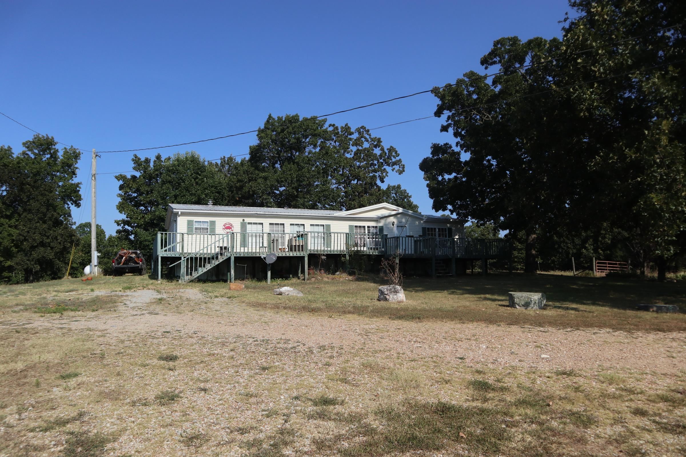 COUNTRY HOME AND ACREAGE FOR SALE NEAR SALEM ARKANSAS  The 3 bedroom 2 bath mfg. home has approx. 1,792 sq. ft. of living area. The home has carpet and vinyl flooring, range, refrig., 2 gas wall heaters, window a/c, gas log fireplace. Also includes a large wood deck on the front of the home. It has rural water and private septic system. Great view from the front of the house. Small storage building. The house sits on 4 acres with highway frontage. Some repairs are needed. House being sold "AS IS". Most of the property is open with a small fenced in area for a few animals. Plenty of space for your garden. Lake Norfork, Spring River and the world famous White River are 30-45 minutes away. Real estate taxes last year were $351. Make your move to the Ozarks and enjoy all this property has to offer.