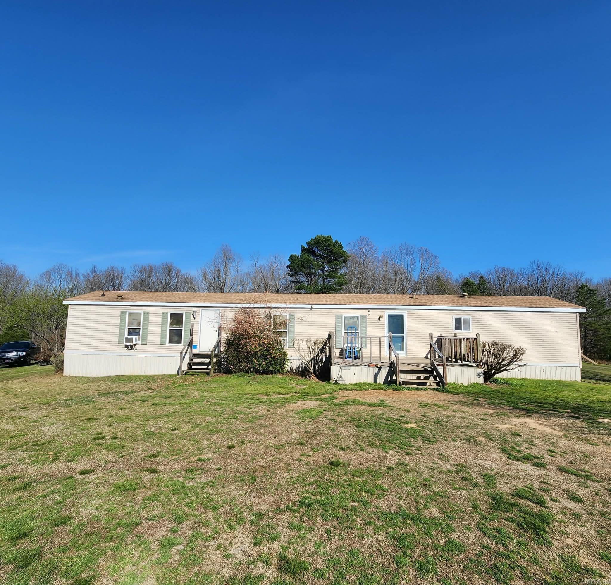 Private country living on a long dirt road to ride utv's or horses on, 3.8 acres completely fenced with gated entry, chicken coop, storage shed, open shop, garden area, producing apple, peach & pear trees, water everywhere needed, all usable land, home sits off road toward back of property.