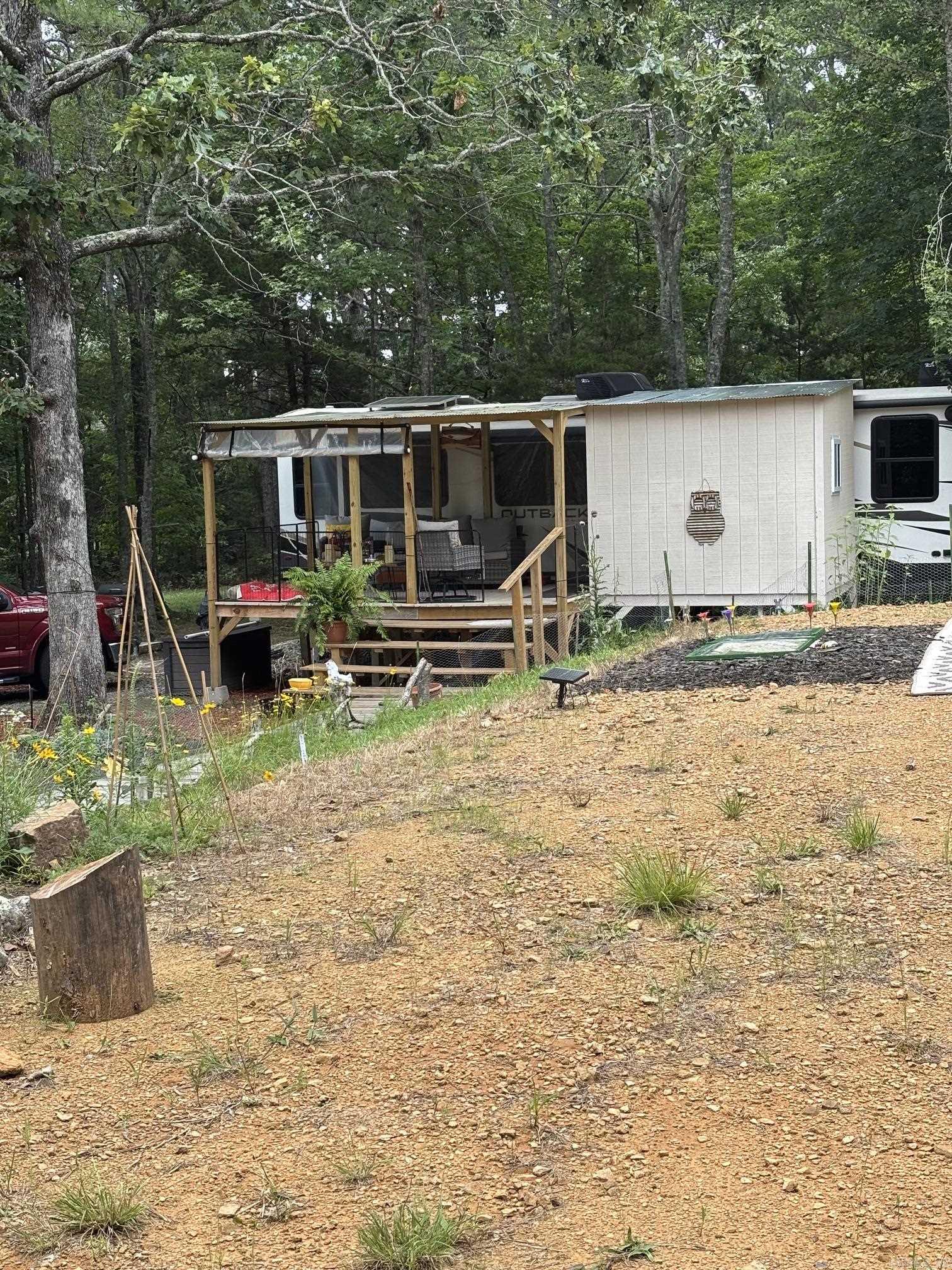 Looking for your own slice of the Ozarks? This move-in-ready property offers 4.84 acres of partially cleared and partially wooded land, giving you the perfect balance of open space and privacy. Whether you're looking for a weekend retreat, full-time residence, or future homestead, this property is ready to enjoy from day one! Included with the property is a 2023 Outback camper that is already set up and ready to use. The RV comes with Solar Panels. Recent improvements include septic, rural water, and electric service installed just a year ago, saving you time and expense. A covered porch has been added, providing a comfortable outdoor living area complete with a washer and dryer and additional storage. The property also features one large storage container, A BBQ Patio, beautiful landscaping with flowers and decorative touches throughout, and plenty of room for a garden, livestock, chickens, or other animals. With no restrictions, you have the freedom to create the lifestyle you've been dreaming of. Located just a short drive from Greers Ferry Lake, you'll enjoy easy access to boating, fishing, swimming, and outdoor recreation. Plus, you're only 15 minutes from Clinton.