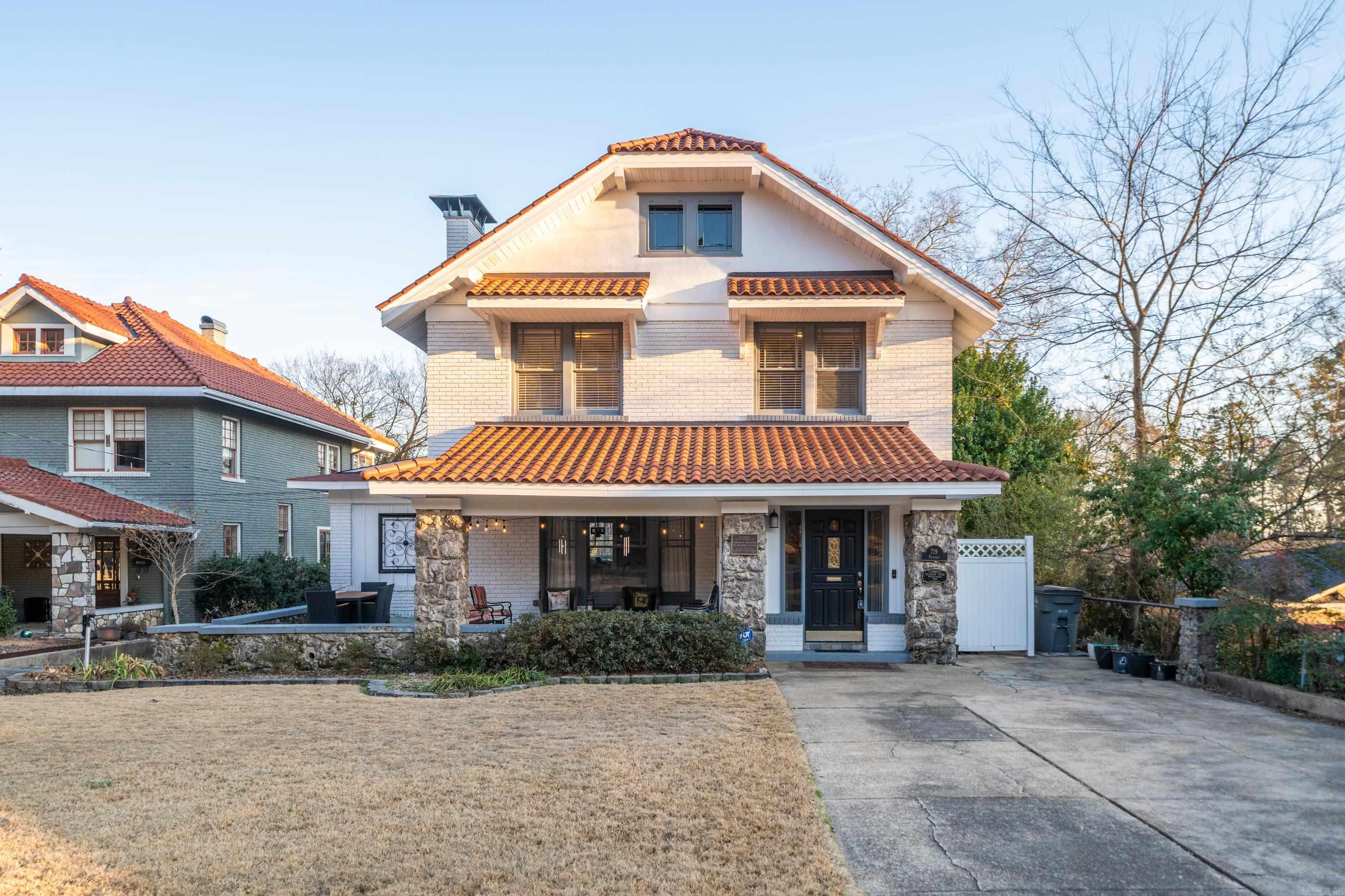 Step into timeless charm with this 1926 Craftsman bungalow, proudly listed on the Historic Register of Historic Homes, and perfectly positioned in the heart of the historic district of downtown Hot Springs. Located at the entrance to West Mountain, this home offers immediate access to scenic hiking trails just across the street—an unbeatable blend of history and nature. With 3 bedrooms, 2 full baths,and 2 half baths, this character-rich residence showcases classic craftsmanship throughout, including hardwood floors, large sun-filled windows, custom built-ins, and a cozy gas fireplace. The home’s historic integrity is beautifully balanced with modern convenience thanks to a completely updated kitchen, ideal for both everyday living and entertaining. The exterior is equally impressive, featuring a mission/barrel-style terracotta tile roof, a welcoming covered front porch, and striking stone details that reflect true Craftsman style. Parking is plentiful with a 2-car carport plus an additional 1-car garage located in the basement area. Overflowing with architectural character, thoughtful updates, and an exceptional location.