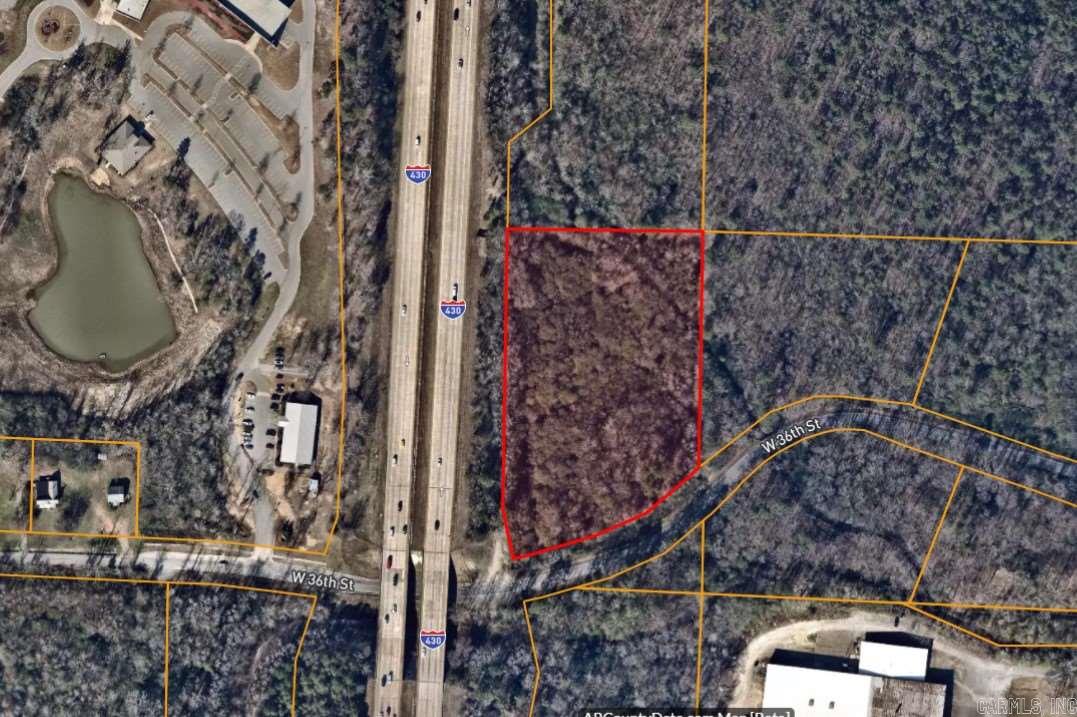 Wooded, level acreage with frontage on I-430 and 36th Street access.  Great location with possible commercial use or multi-family housing.