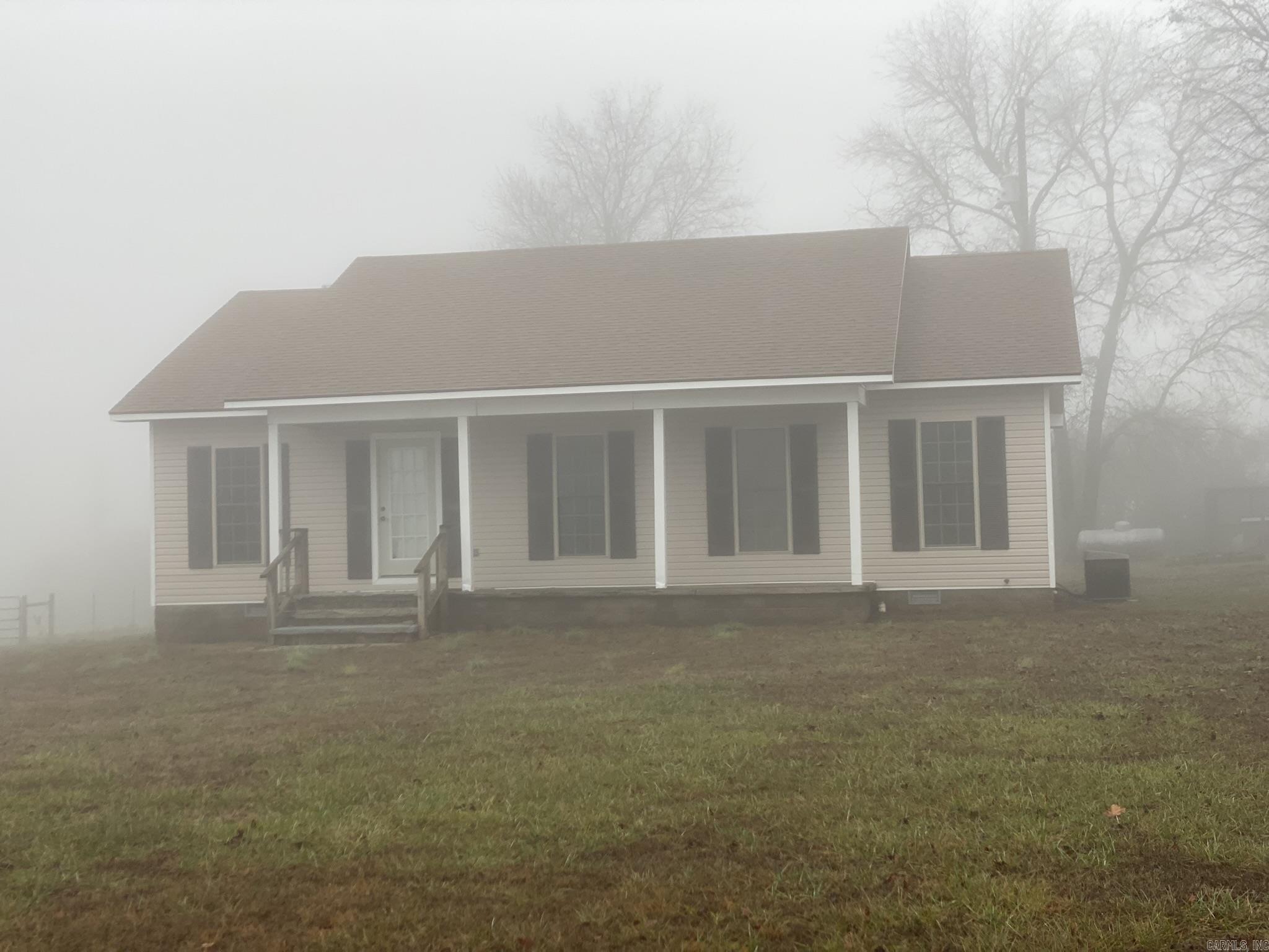 Country home located on paved road. Located in Searcy County, this property has a large shop, garden place, chicken coop and stable with a pony pasture.