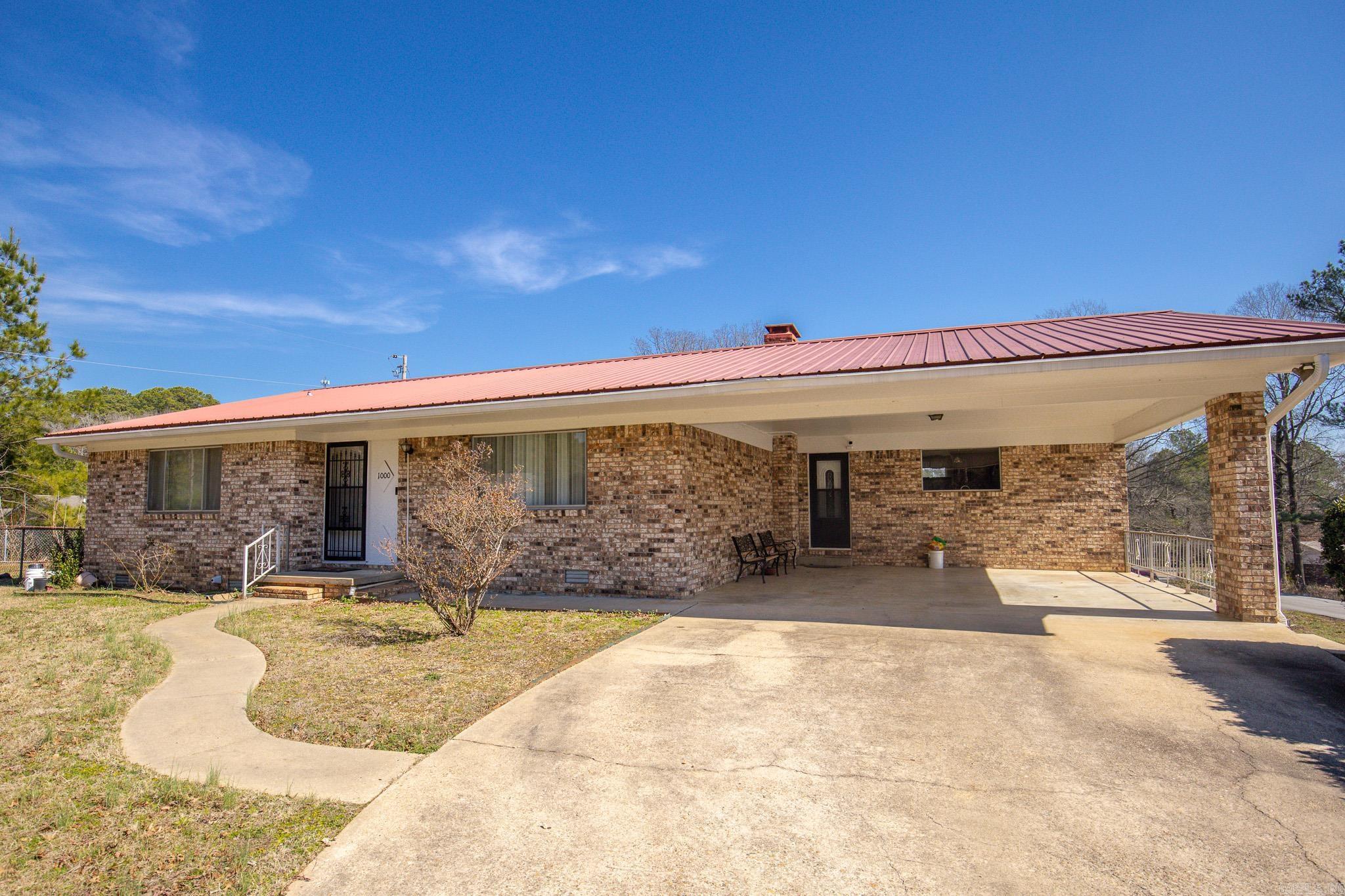 This 4 bedroom, 3 bath home offers 2460 sq ft of comfortable living space inside the city limits and just minutes from everything in town.  Sitting on a generous corner lot (0.66 Acre). The updated kitchen brings a fresh touch to the home and serves as the heart of the main level, as well as a living room with wood burning fireplace. There is plenty of room for a large family or social gatherings in this home. Outside you'll find a workshop for hobbies or extra storage, along with a paved drive and two car carport.  If you're looking for solid bones, space to grow, and the opportunity to make a home your own, this property is ready for its next chapter!
