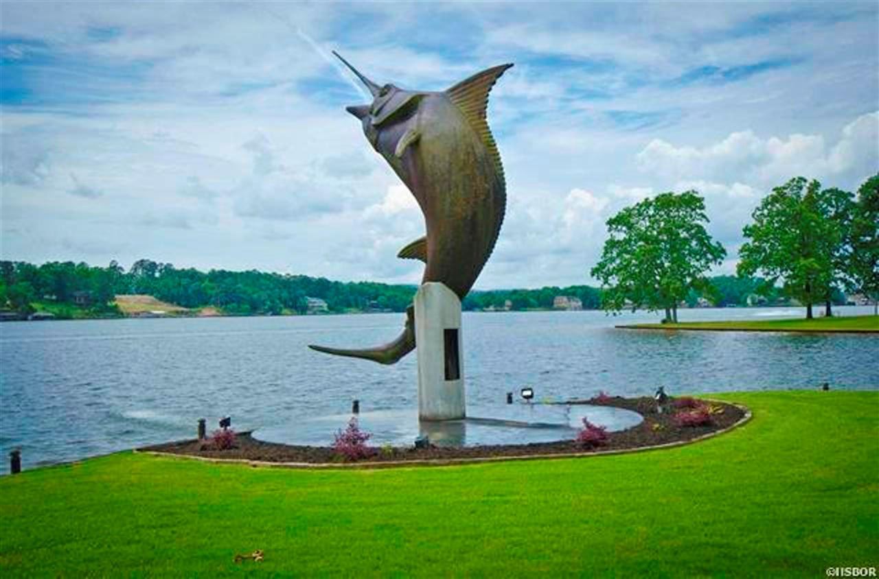 Luxury showstopper on Lake Hamilton! It's your chance to own the "Marlin House". This 4 /4.5, 6924 sq ft home features a spacious Chefs kitchen, Large game room w/Cali bamboo flooring, Huge Master w/ ensuite, Office, Wet bar, Living area w/ floor to ceiling stone FP, Sauna. Heated/Cooled 2400 sq ft. 4 car garage & workshop space w/tons of storage. 1200 sq ft studio garage guest apartment large kitchen w/ breakfast bar, professional cooler, d/w & ice maker, 1/2bath, new flooring & new 240 sq ft deck.