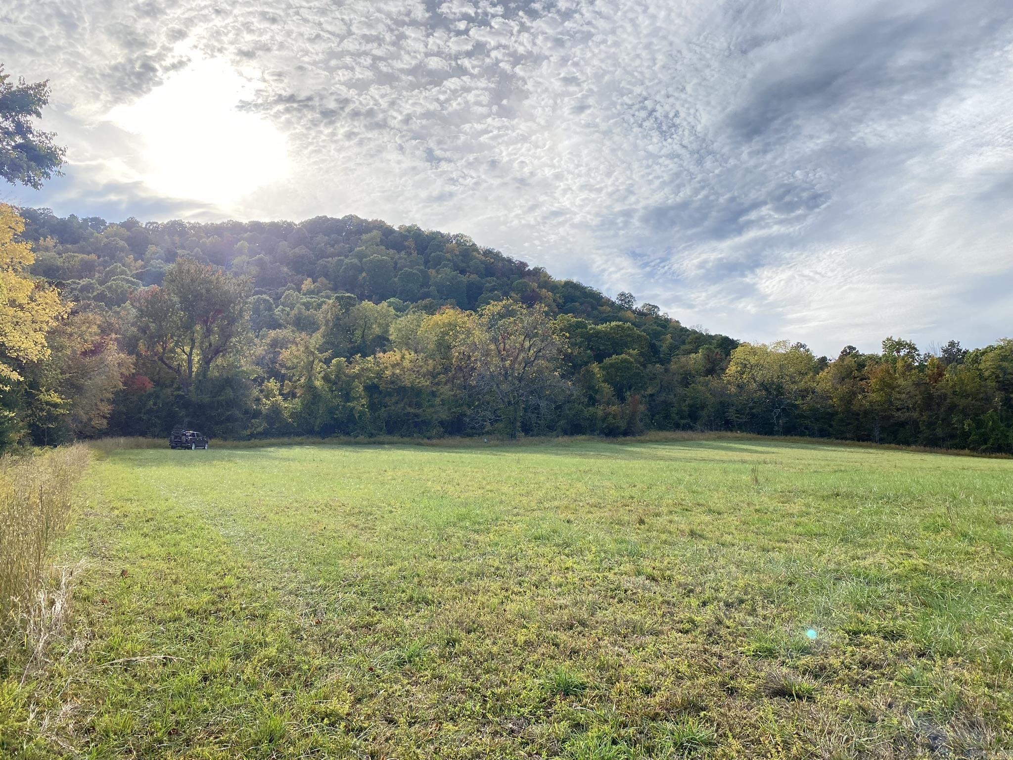 7.3 ACRE RECREATIONAL PROPERTY FOR SALE IN OZARK MOUNTAINS Situated between Mountain Home and Mountain View, Arkansas, this 5 acre property sits nestled in the Ozark Mountains, offering a prime location for outdoor enthusiasts.  It's conveniently located near the Ozark-St. Francis National Forest and the Buffalo National River, making it a haven for nature lovers.  Additionally, the property offers quick access to the White River, a mere 15 minute drive in multiple directions, which is ideal for fishing and other water-based adventures.  Fronting Hwy 341, this property provides convenient access for those seeking a peaceful getaway. Electricity is available at the road, ensuring modern conveniences are within reach.  Embrace this unique land opportunity for only $69,900.