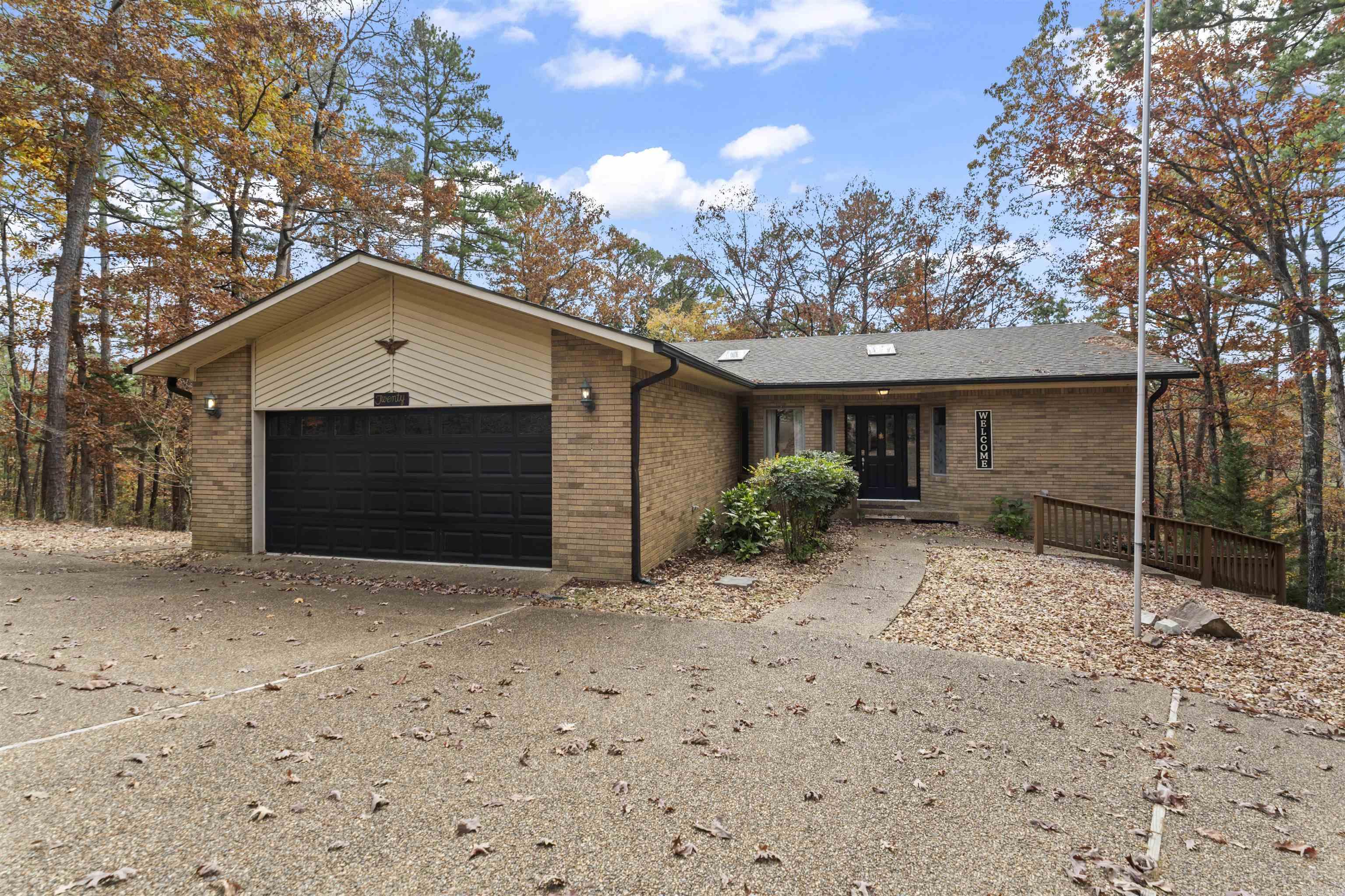 Welcome to 20 Gerona Circle, a beautifully updated 2,878 sq ft home in the heart of Hot Springs Village—the largest gated community in the United States. This home blends modern updates, flexible living space, and a lifestyle filled with recreation, nature, and security.  Inside, the main level offers an open, airy layout, new interior paint, new ceiling fans, and fresh upstairs flooring.  The living and dining areas flow seamlessly, enhanced by natural light from skylights and two patio doors. The kitchen features a new backsplash and appliances that convey.  This level includes two comfortable bedrooms and two full bathrooms, supported by major system upgrades—roof replaced in late 2020 and HVAC in late 2019. The two-story fully screened in porch extends your living space outdoors, offering year-round enjoyment of the surrounding wooded landscape. The lower level adds versatility with a dedicated craft area, a full third bedroom, a bonus room perfect as a fourth sleeping space, office, or gym. This level also includes the third bathroom, a large laundry room, new light fixtures, and a storage room spanning the width of the home. Schedule your private showing today.