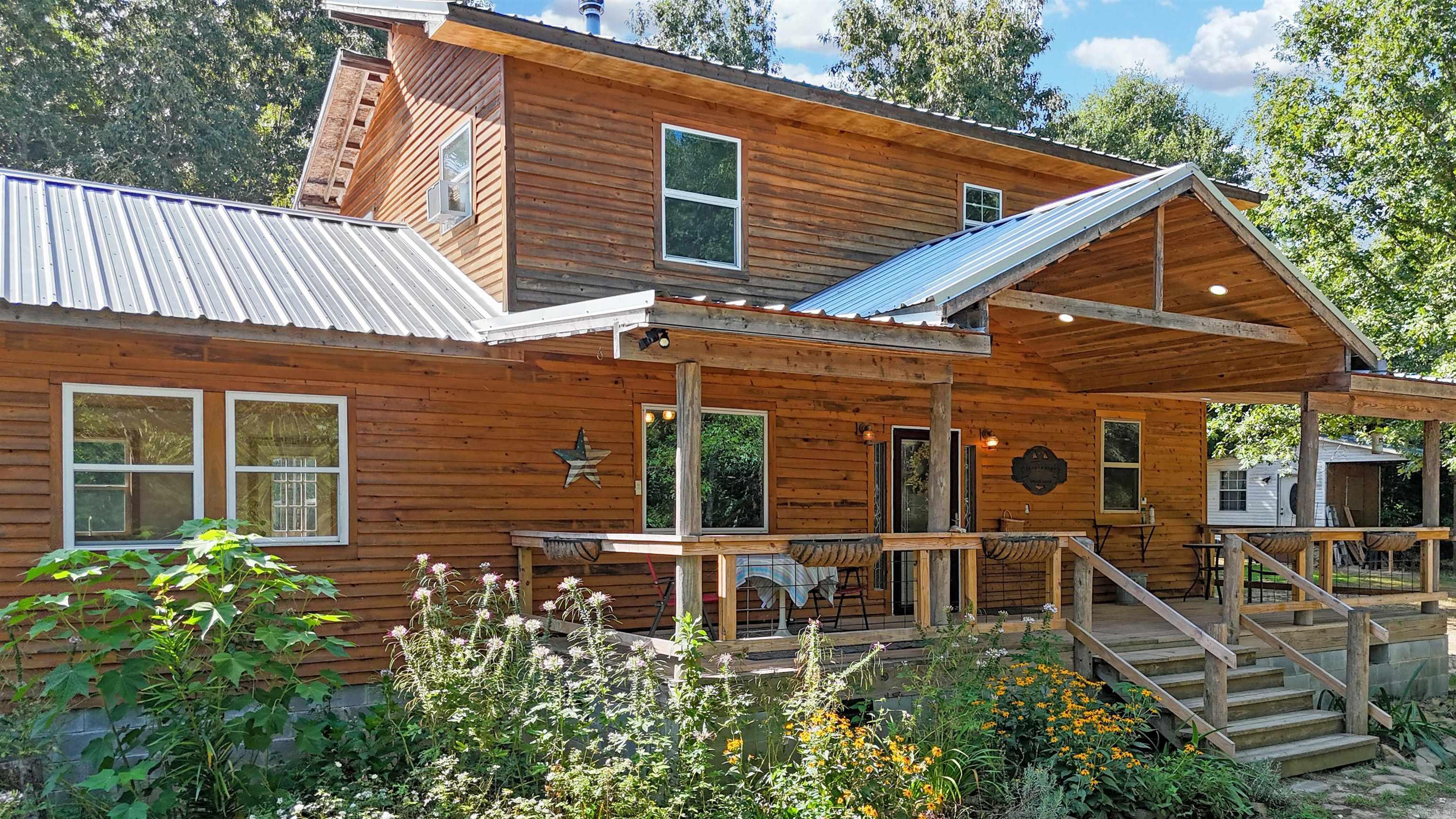 Privacy, tranquility, and space come together in this one-of-a-kind property! Nestled on 12.79 acres at the end of a private road, this beautiful country home showcases cypress siding and 3 decks to unwind and relax while watching the wildlife stroll through the property. The private retreat offers approx. 2,240 square feet of living space with the primary bedroom and bath on the main level. The inviting open kitchen, dining, and living area features cedar wood ceilings, exposed beams, lots of windows, wood floors, and a Manchester soapstone wood-burning stove with a porcelain finish. The kitchen features a generous 6’ x 5’ island, Italian marble tile countertops, maple/birch cabinetry, and a triple-bowl top-mount sink. Additional features include an outbuilding, RV hookups, trails throughout the property leading to the spring fed creek, fenced raised-bed garden, and cleared area with livestock shed and fencing already in place. The sellers have completed numerous improvements and upgrades during their ownership, creating a property that is ready to enjoy. A detailed list of improvements is available to highlight the extensive work completed. Schedule your private tour today!